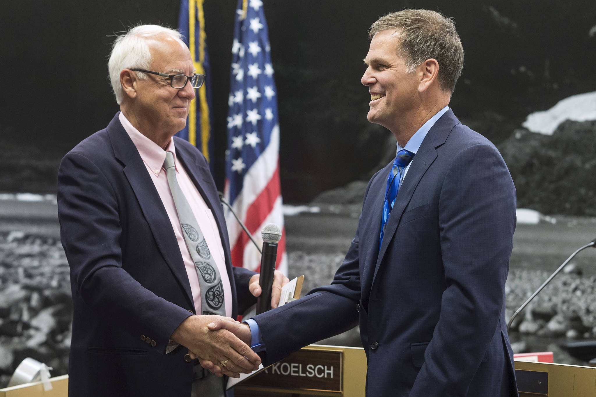 Outgoing Mayor Ken Koelsch, left, thanks Assembly member Jerry Nankervis for his service in the Assembly chambers on Monday, Oct. 15, 2018. (Michael Penn | Juneau Empire)