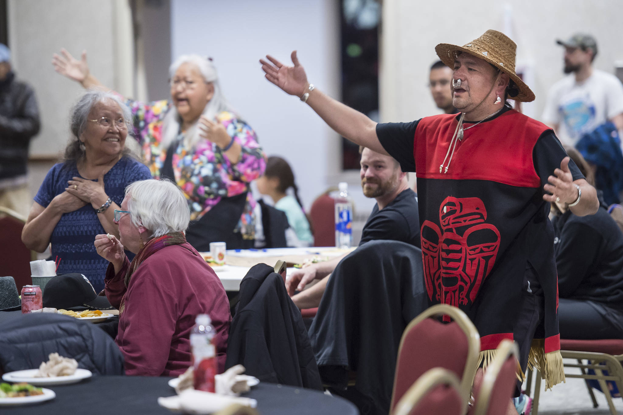 Lillian Hillman, left, watches as Woosh.ji.een Dance Group dancer John Garcia performs during a Celebrate Survivors gathering sponsored by Central Council Tlingit and Haida Indian Tribes of Alaska and AWARE in the Elizabeth Peratrovich Hall on Tuesday, Oct. 23, 2018. October is Domestic Violence Awareness Month. (Michael Penn | Juneau Empire)