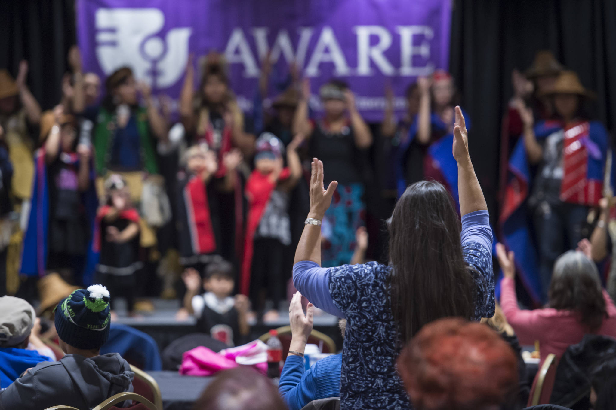 People pay tribute to the Woosh.ji.een Dance Group as they perform during a Celebrate Survivors gathering sponsored by Central Council Tlingit and Haida Indian Tribes of Alaska and AWARE in the Elizabeth Peratrovich Hall on Tuesday, Oct. 23, 2018. October is Domestic Violence Awareness Month. (Michael Penn | Juneau Empire)