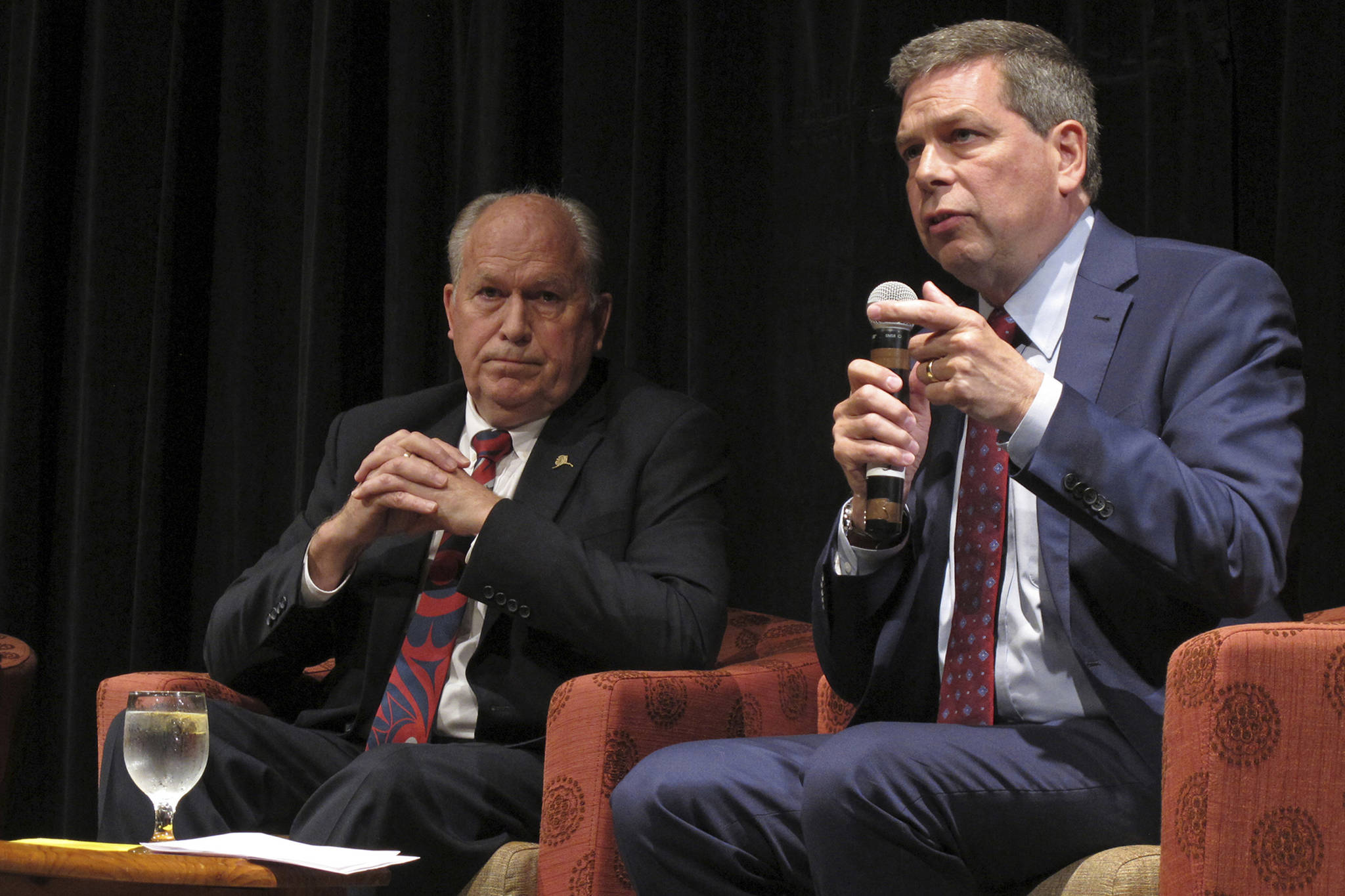 In this Sept. 6, 2018 file photo, Democratic nominee for governor of Alaska Mark Begich, right, speaks as Gov. Bill Walker listens during a chamber of commerce gubernatorial candidate forum on Thursday, Sept. 6, 2018, in Juneau, Alaska, On Friday, Oct. 19, Walker announced he was dropping his bid for re-election, though his name remains on the ballot. He threw his support behind Begich, who will face Republican Mike Dunleavy in November. (AP Photo | Becky Bohrer File)