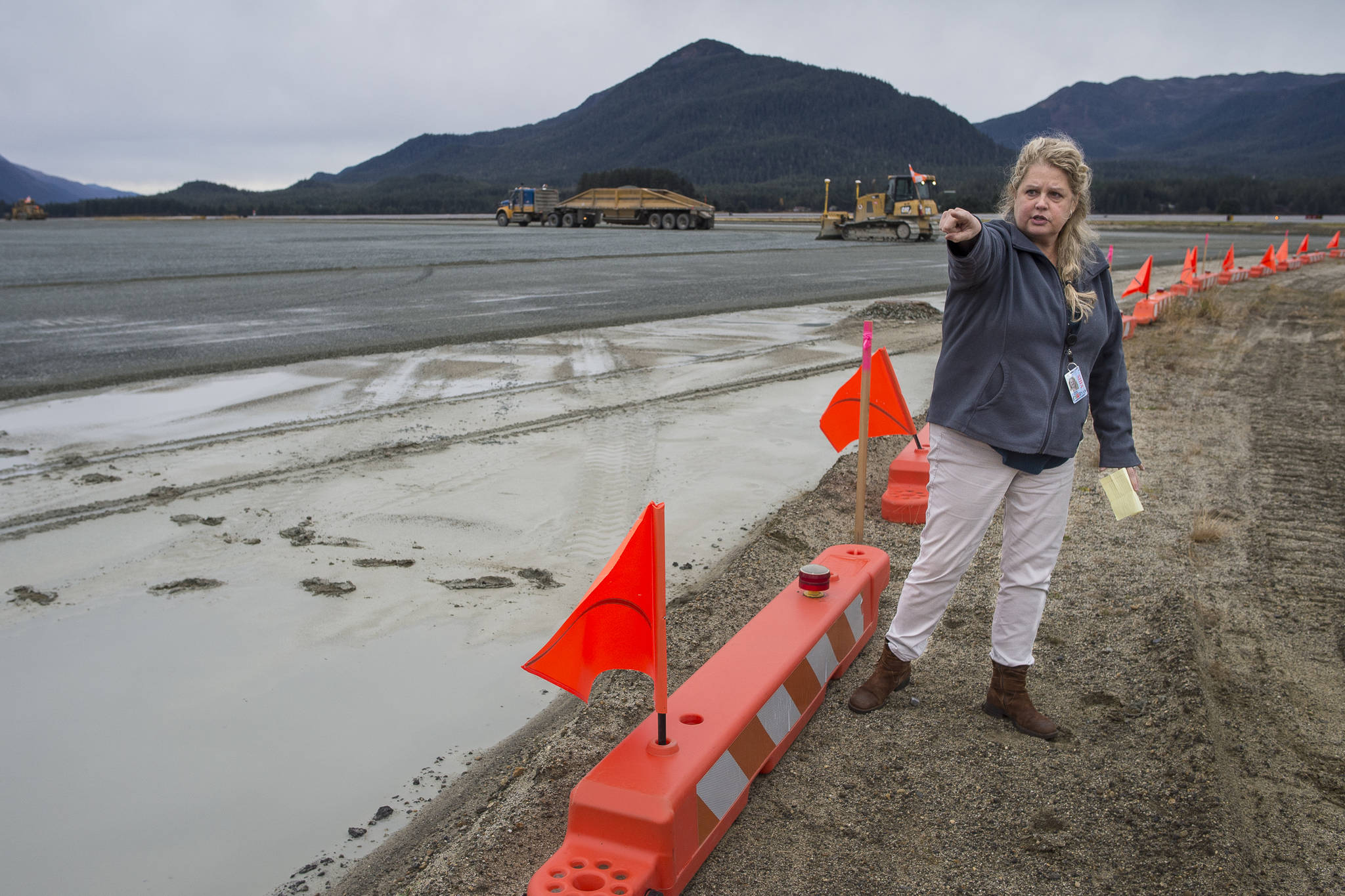 Juneau International Airport Manager Patty Wahto points out a new paving project on the southeast corner of the airport to allow for new hangers and more parking of planes and jets on Wednesday, Oct. 24, 2018. (Michael Penn | Juneau Empire)