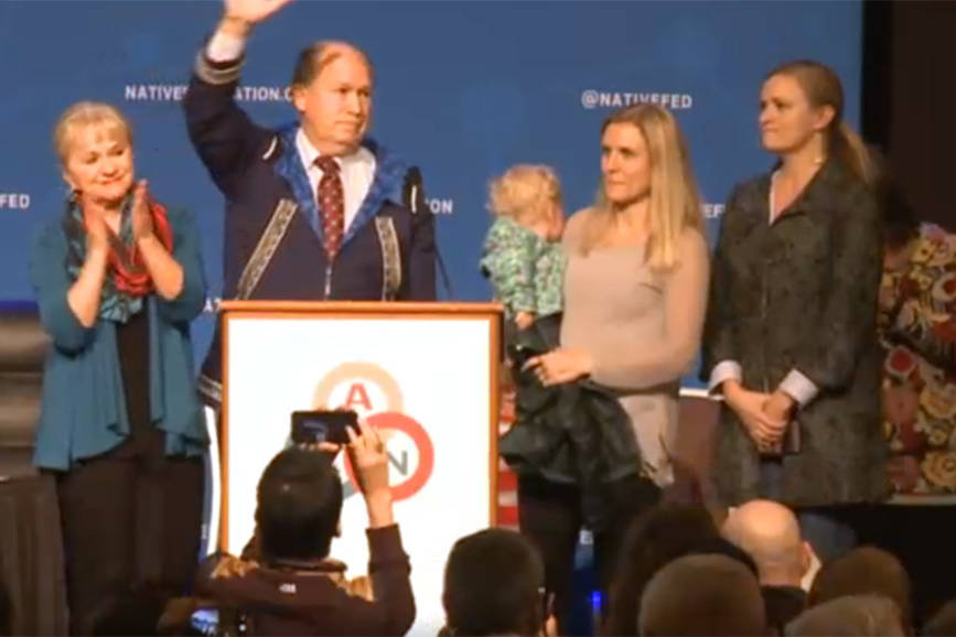 In this screenshot from a video stream provided by the Alaska Federation of Natives, Gov. Bill Walker waves to the crowd on Friday, Oct. 19, 2018 after announcing that he has suspended his bid for re-election and is supporting the Democratic candidate, Mark Begich. (Screenshot)