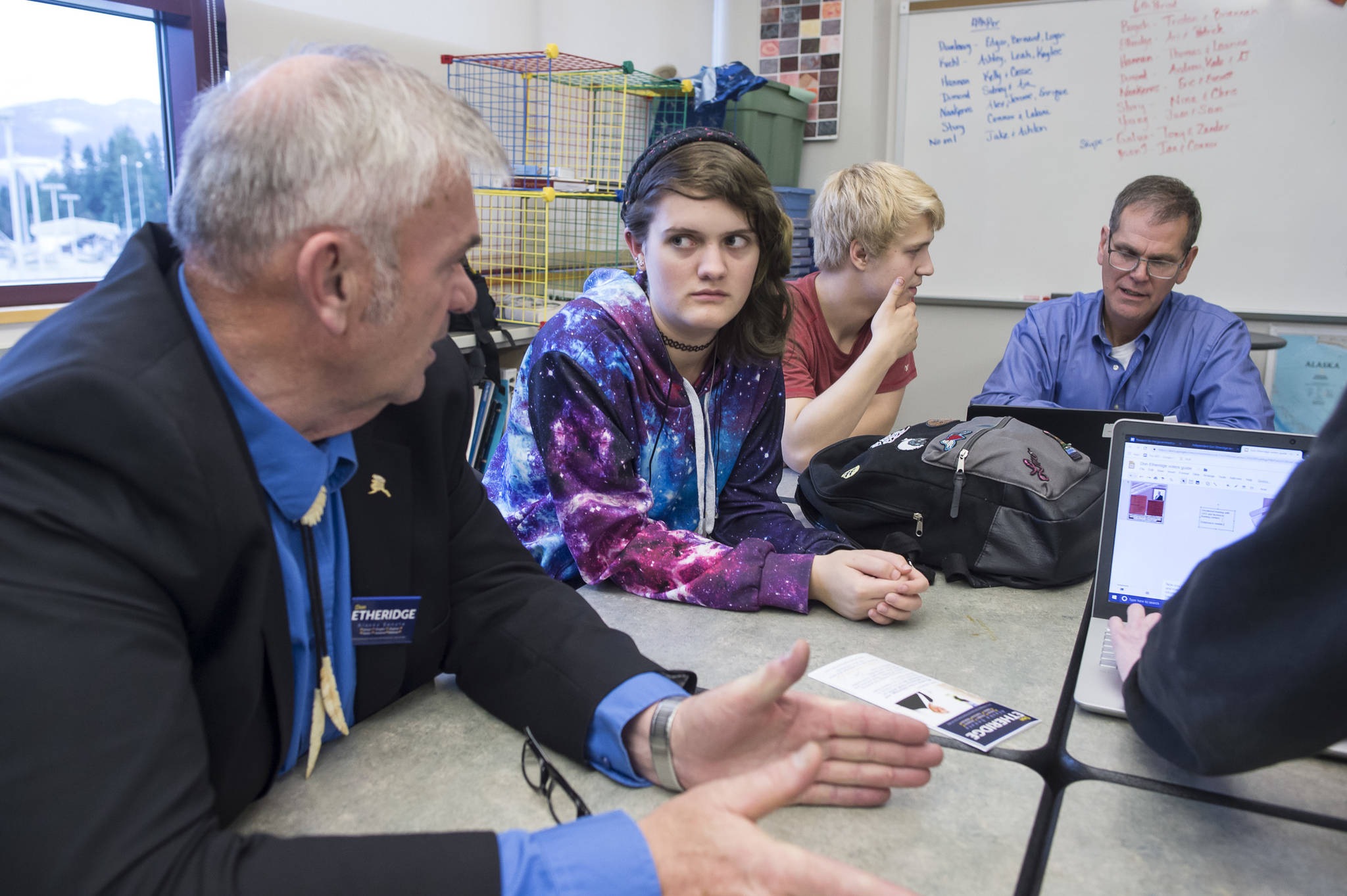 Senate District Q candidate Don Etheridge, left, and House District 34 candidate Jerry Nankervis, right, talk with Thunder Mountain High School senior students Arianna Csech, center, and Eric Sidney during their government class on Friday, Oct. 26, 2018. (Michael Penn | Juneau Empire)
