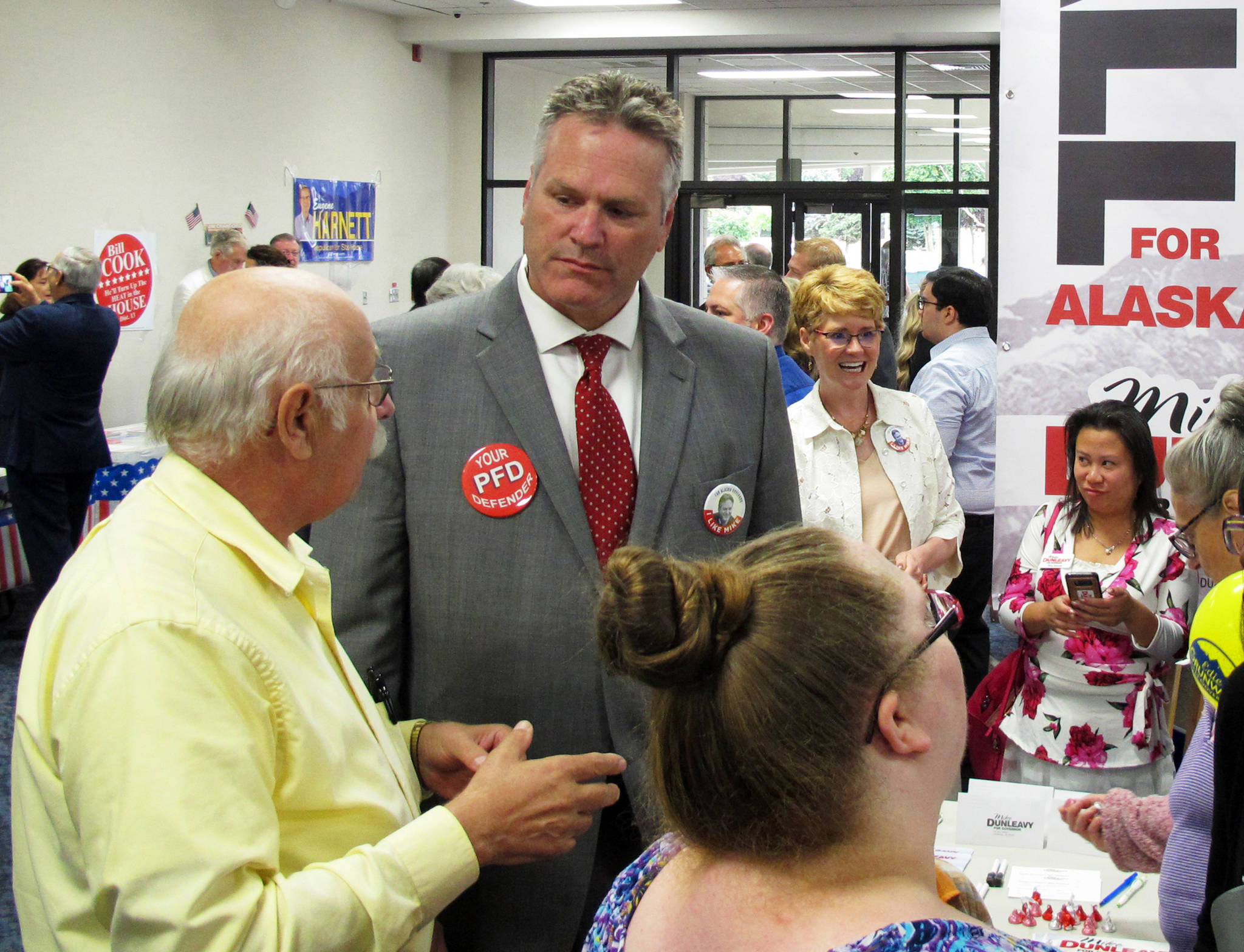 FILE - In this Aug. 19, 2018 file photo, Republican gubernatorial candidate Mike Dunleavy, second from left, stands near his campaign table at a meet-and-greet event in the lobby of Anchorage Baptist Temple in Anchorage, Alaska. As a kid growing up on the East Coast, Mike Dunleavy dreamed of coming to Alaska, of hunting caribou, fishing in wild streams and losing himself in the state’s vast, open spaces. Now, after nearly 35 years in his adopted state, the conservative Republican is vying to become Alaska’s next governor. (AP Photo/Becky Bohrer, File)                                In this Aug. 19 file photo, Republican gubernatorial candidate Mike Dunleavy, second from left, stands near his campaign table at a meet-and-greet event in the lobby of Anchorage Baptist Temple in Anchorage. (Becky Bohrer | The Associated Press File)