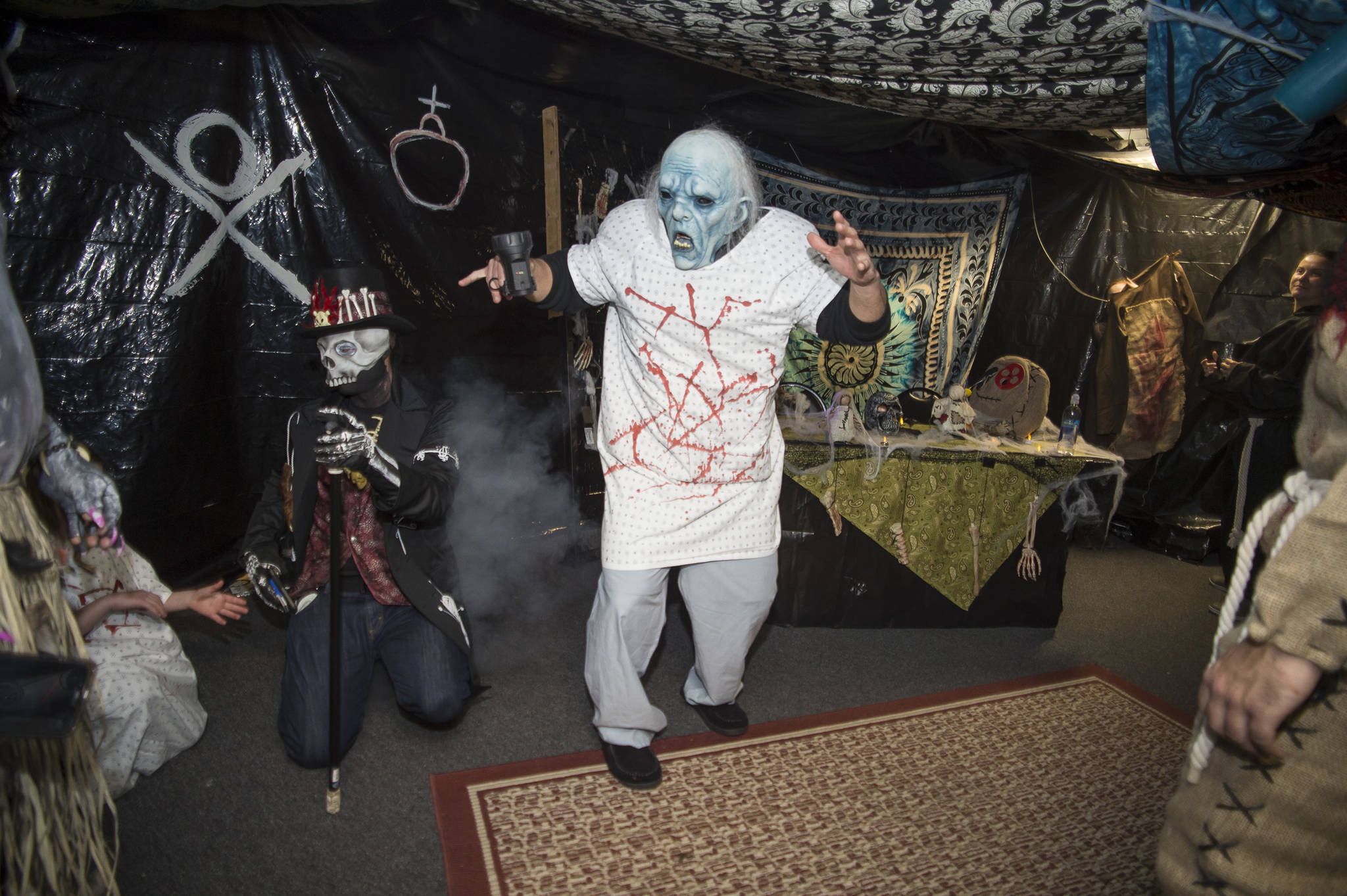 Juneau residents react to scares and chills as they make their way through the Haunted Station at the U.S. Coast Guard’s Station Juneau on Friday, Oct. 26, 2018. Station personnel pay for all the decoration themselves and take three weeks to ready the station. Entry is non perishable food items for the Southeast Alaska Food Bank. (Michael Penn | Juneau Empire)