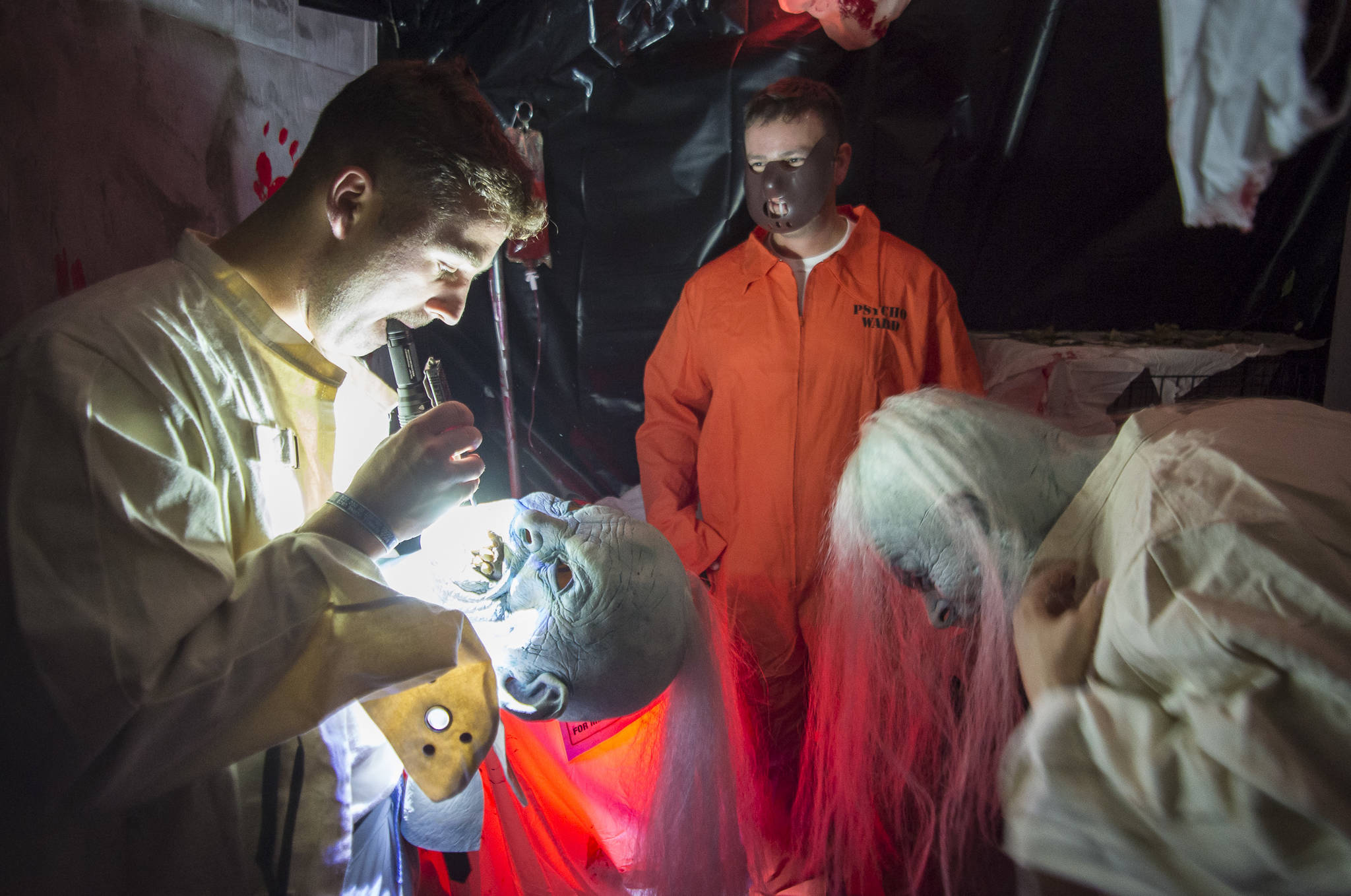 Anthonyu Hotka customizes his mask at the Haunted Station at the U.S. Coast Guard’s Station Juneau on Friday, Oct. 26, 2018. Station personnel pay for all the decoration themselves and take three weeks to ready the station. Entry is non perishable food items for the Southeast Alaska Food Bank. (Michael Penn | Juneau Empire)