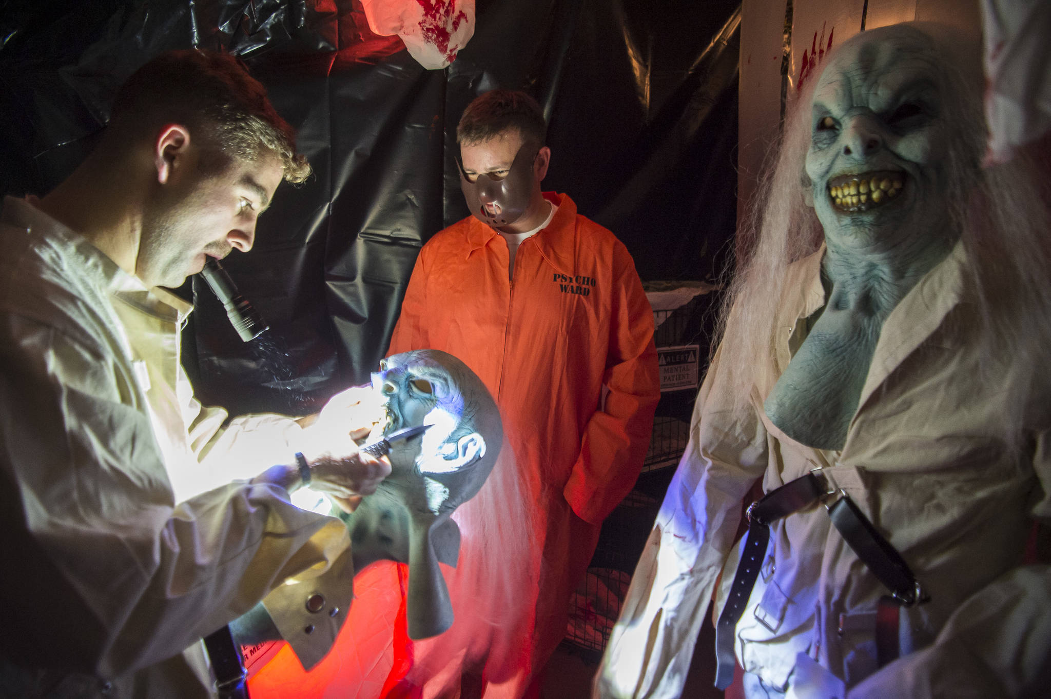 Anthony Hotka customizes his mask at the Haunted Station at the U.S. Coast Guard’s Station Juneau on Friday, Oct. 26, 2018. Station personnel pay for all the decoration themselves and take three weeks to ready the station. Entry is non perishable food items for the Southeast Alaska Food Bank. (Michael Penn | Juneau Empire)