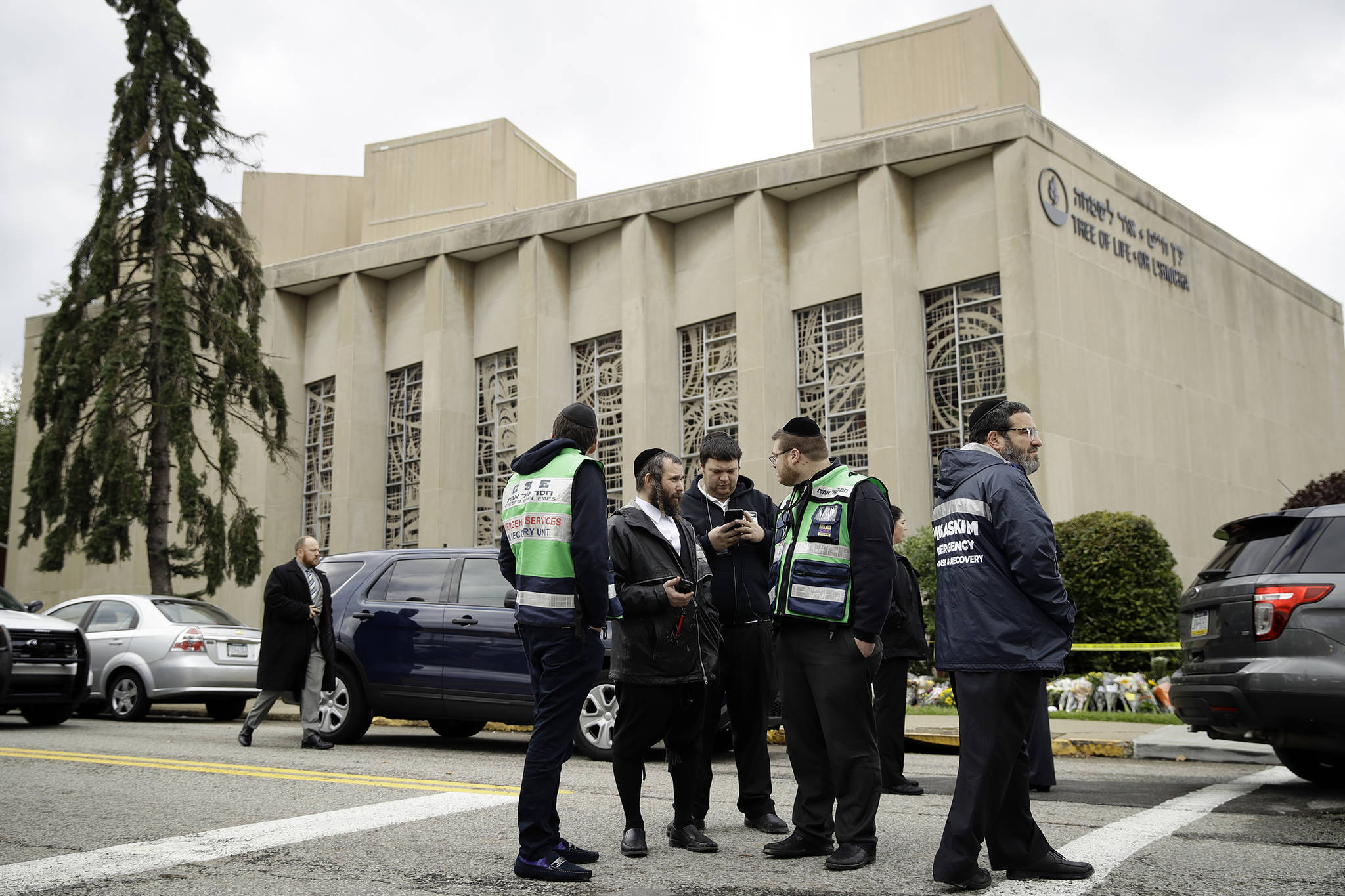 Personnel from Chesed Shel Emes Emergency Services and Recovery Unit gather near the Tree of Life Synagogue in Pittsburgh, Sunday, Oct. 28, 2018. Robert Bowers, the suspect in the mass shooting at the synagogue, expressed hatred of Jews during the rampage and told officers afterward that Jews were committing genocide and he wanted them all to die, according to charging documents made public Sunday. (AP Photo/Matt Rourke)