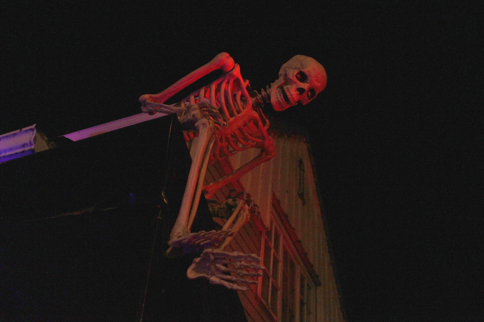 A skeleton watches over the Jones home at the corner of 10th Street and Glacier Avenue on Monday, Oct. 29, 2018. The house becomes the Witch’s Haunted House for a few hours every Halloween, welcoming around 400 people into the basement for a scare or several. (Alex McCarthy | Juneau Empire)