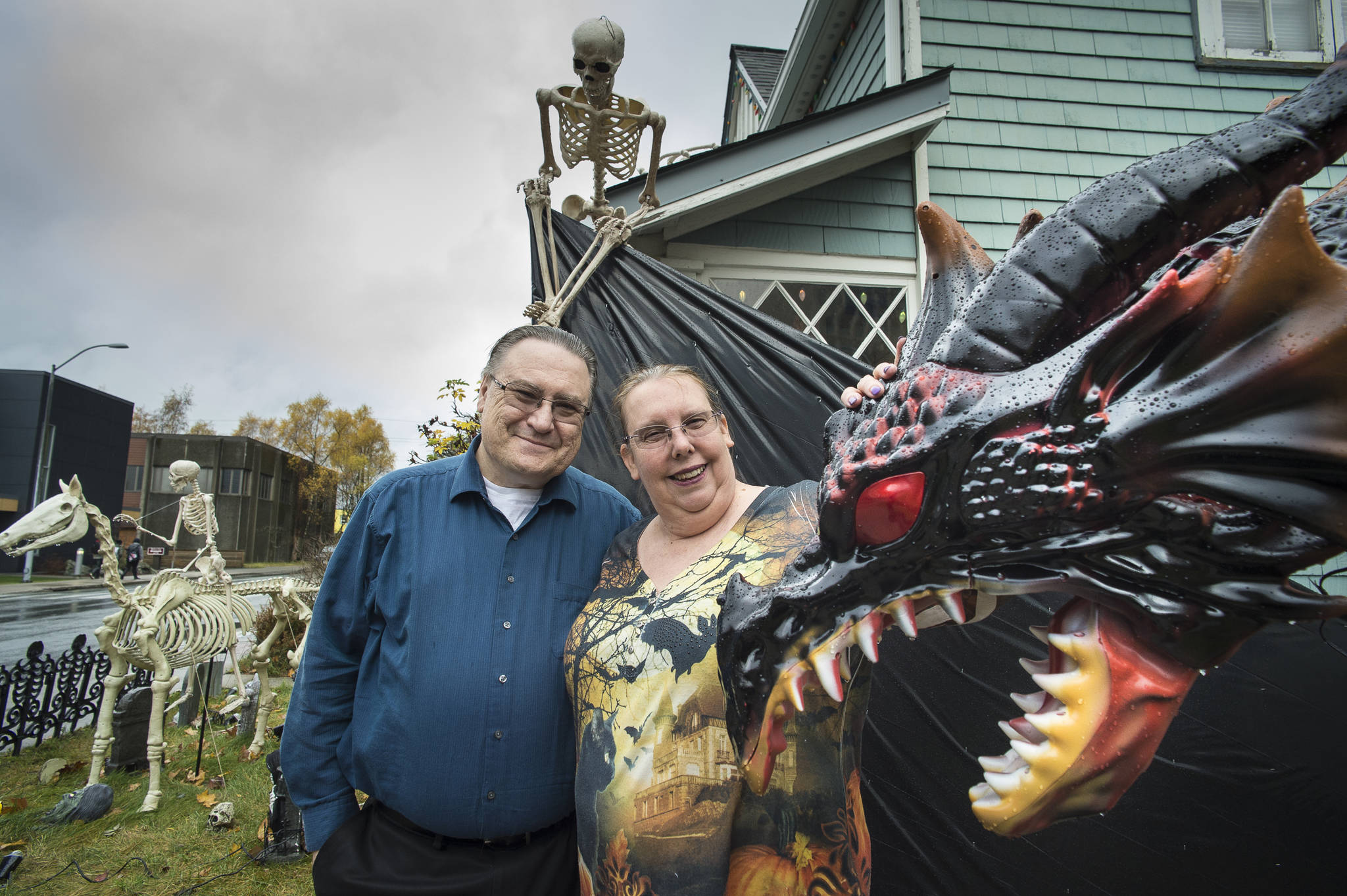 Will and Mindy Jones pose with some of their many Halloween decorations at their home at the corner of 10th Street and Glacier Avenue on Tuesday, Oct. 30, 2018. The Jones have been decorating their home for the last 14 years and expect to nearly 400 visitors this year. Mindy said, “If you don’t like spiders, this isn’t the place for you.” (Michael Penn | Juneau Empire)