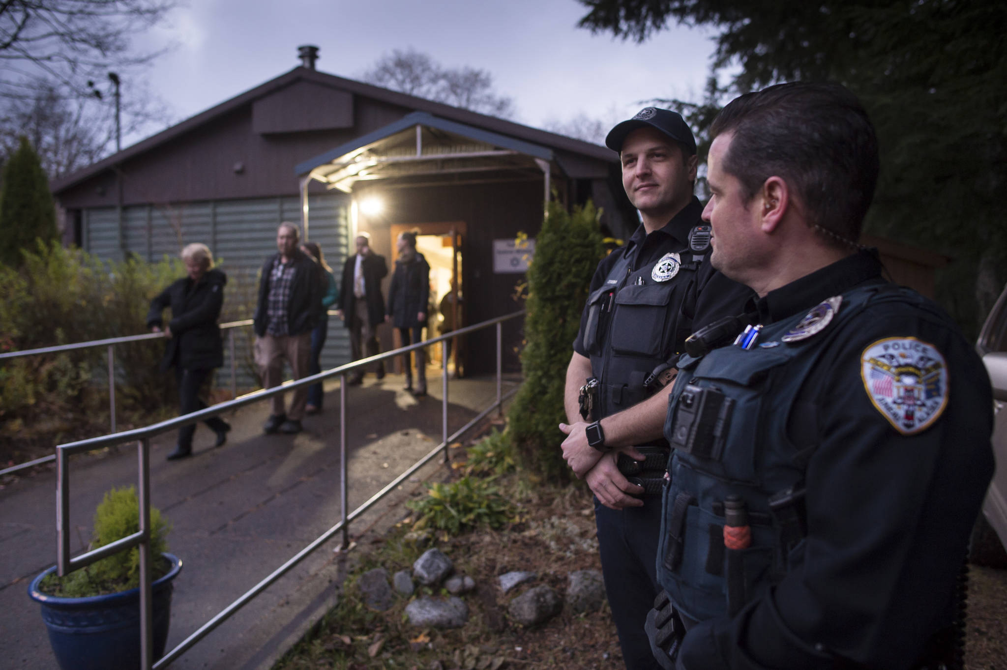 Juneau Police Officers Brent Bartlett, right, and John Cryderman provide a security presence at Temple Sukkat Shalom on Tuesday, Oct. 30, 2018, where Juneau residents gathered to honor the memory of the people killed by a gunman at the Tree of Life synagogue in Pittsburgh, Pennsylvania, on Saturday. (Michael Penn | Juneau Empire)