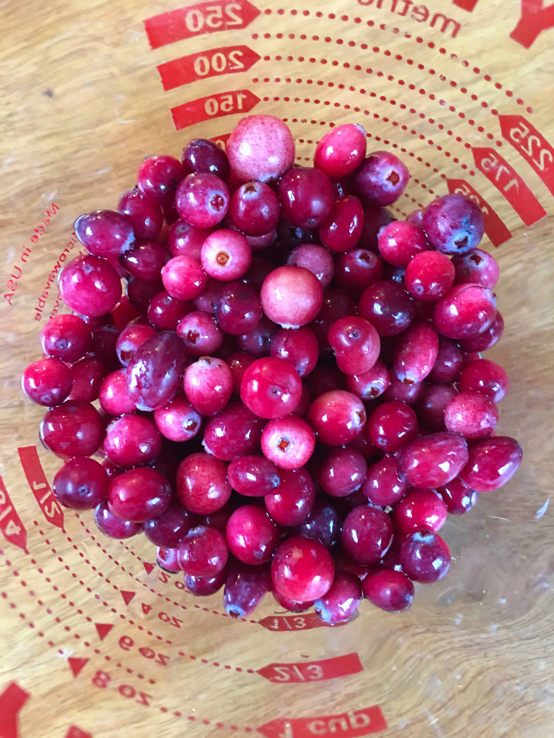 A measuring cup full of bog cranberries (Vaccinium oxycoccos) is seen in the kitchen of Erin Anais Heist on Oct. 14, 2018. (Erin Anais Heist | For the Juneau Empire)