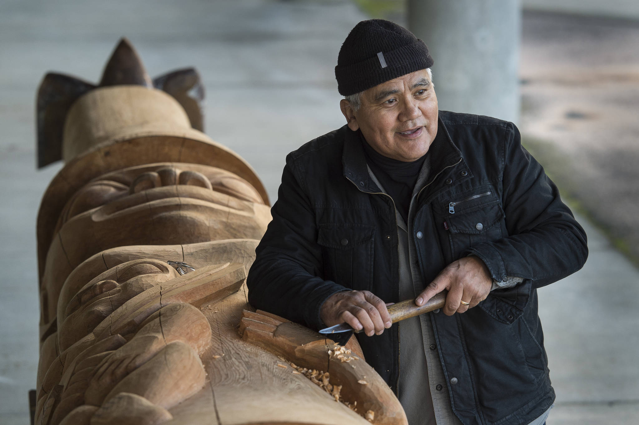 Wayne Price, master Tlingit carver and Associate Professor of Northwest Coast Arts and Sciences, works on a healing pole at the University of Alaska Southeast on Wednesday, Oct. 31, 2018. The pole will be erected with a screen at AWARE’s women’s transitional housing at Twin Lakes in April. (Michael Penn | Capital City Weekly)