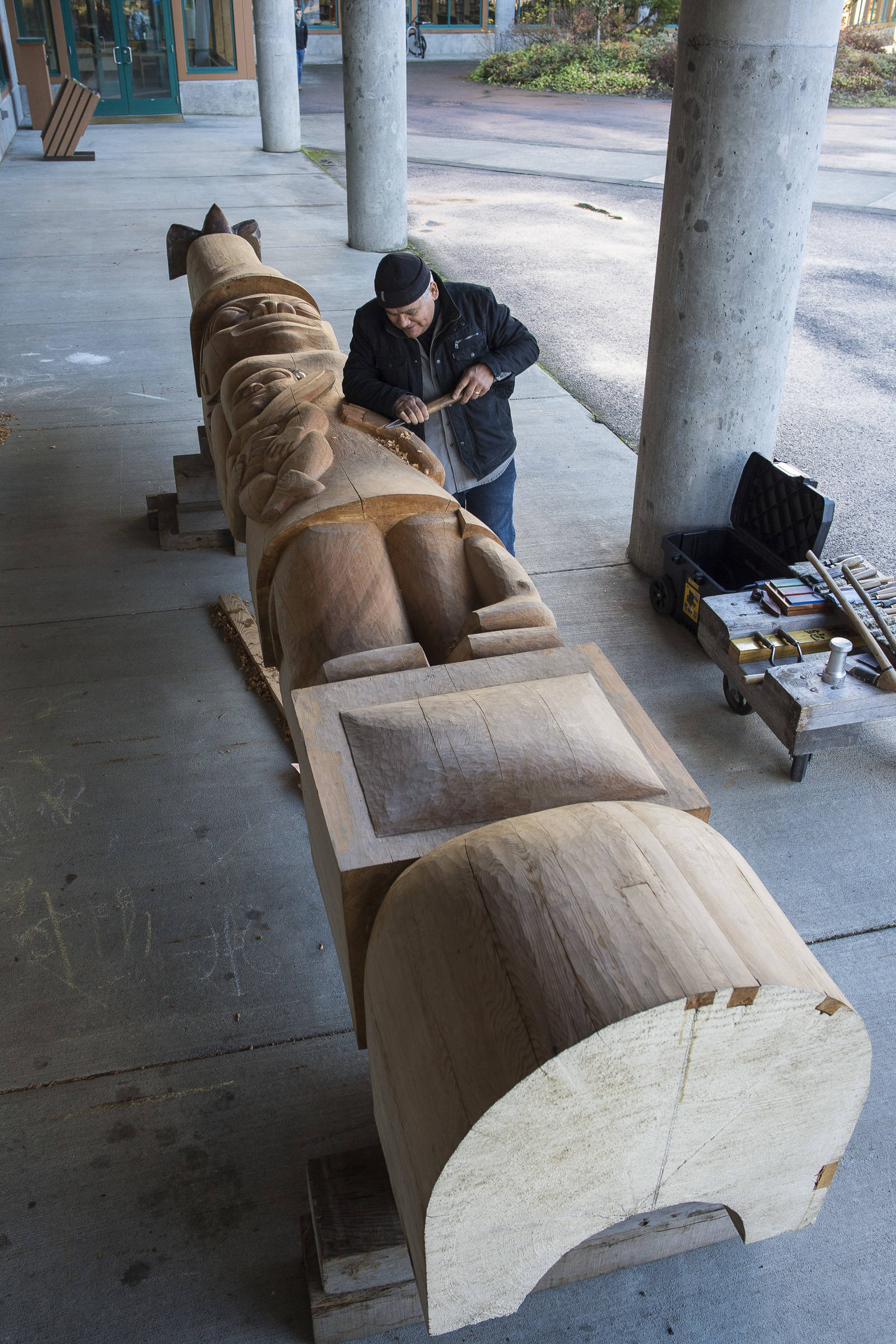 Wayne Price, master Tlingit carver and Associate Professor of Northwest Coast Arts and Sciences, works on a healing pole at the University of Alaska Southeast on Wednesday, Oct. 31, 2018. The pole will be erected with a screen at AWARE’s women’s transitional housing at Twin Lakes in April. (Michael Penn | Capital City Weekly)