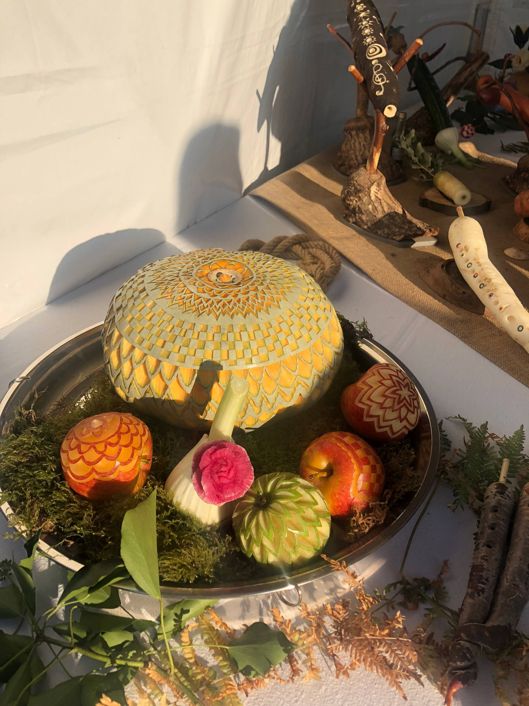 Carved pumpkins and apples on display in an artist’s tent on Oct. 21, 2018. (Bridget McTague | For the Juneau Empire)