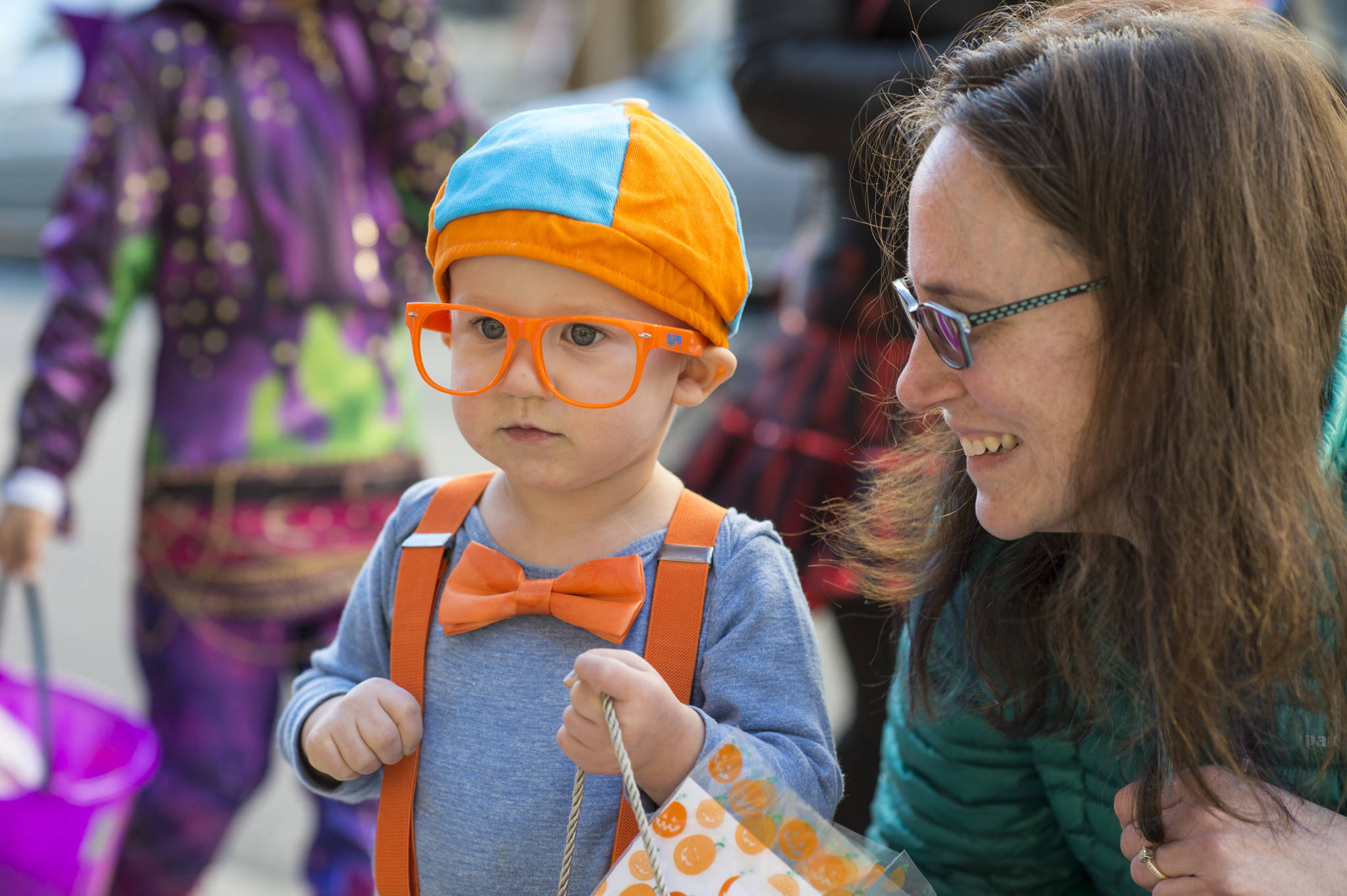Leah Heiman watches her son, Evan, 2, as they visit downtown merchants for Halloween on Wednesday, Oct. 31, 2018. For the fourth year Kindred Post has organized the Halloween celebration for trick-or-treaters. (Michael Penn | Juneau Empire)