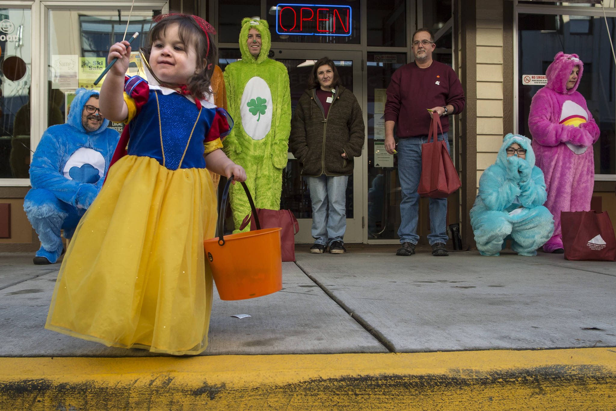 Ryelynn Wilhite examines a pencil she receives for Halloween from the employees of Front Street Clinic on Wednesday, Oct. 31, 2018. For the fourth year Kindred Post has organized the Halloween celebration for trick-or-treaters. (Michael Penn | Juneau Empire)