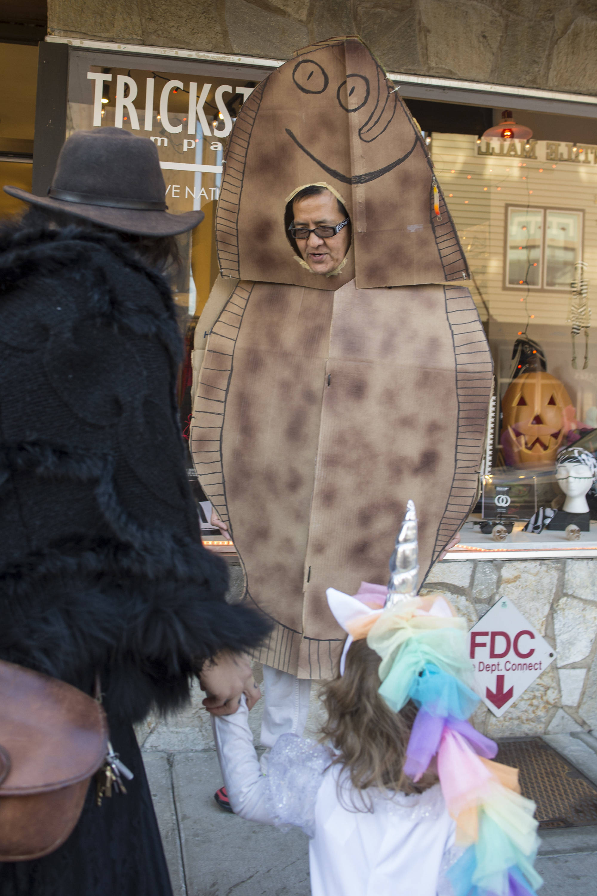 Ricardo Worl greets trick-or-treaters outside of Trickster on Wednesday, Oct. 31, 2018. For the fourth year Kindred Post has organized the Halloween celebration for trick-or-treaters. (Michael Penn | Juneau Empire)                                Ricardo Worl greets trick-or-treaters outside of Trickster on Wednesday, Oct. 31, 2018. For the fourth year Kindred Post has organized the Halloween celebration for trick-or-treaters. (Michael Penn | Juneau Empire)