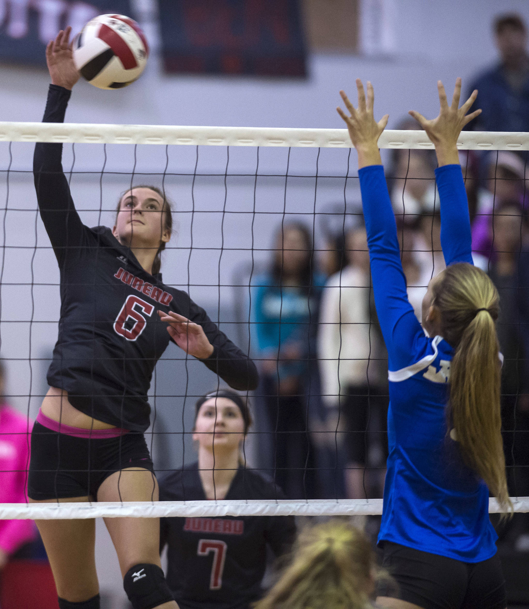 Juneau-Douglas’ Addie Prussing, left, spikes the ball against Thunder Mountain at JDHS on Friday, Oct. 5, 2018. (Michael Penn | Juneau Empire File)