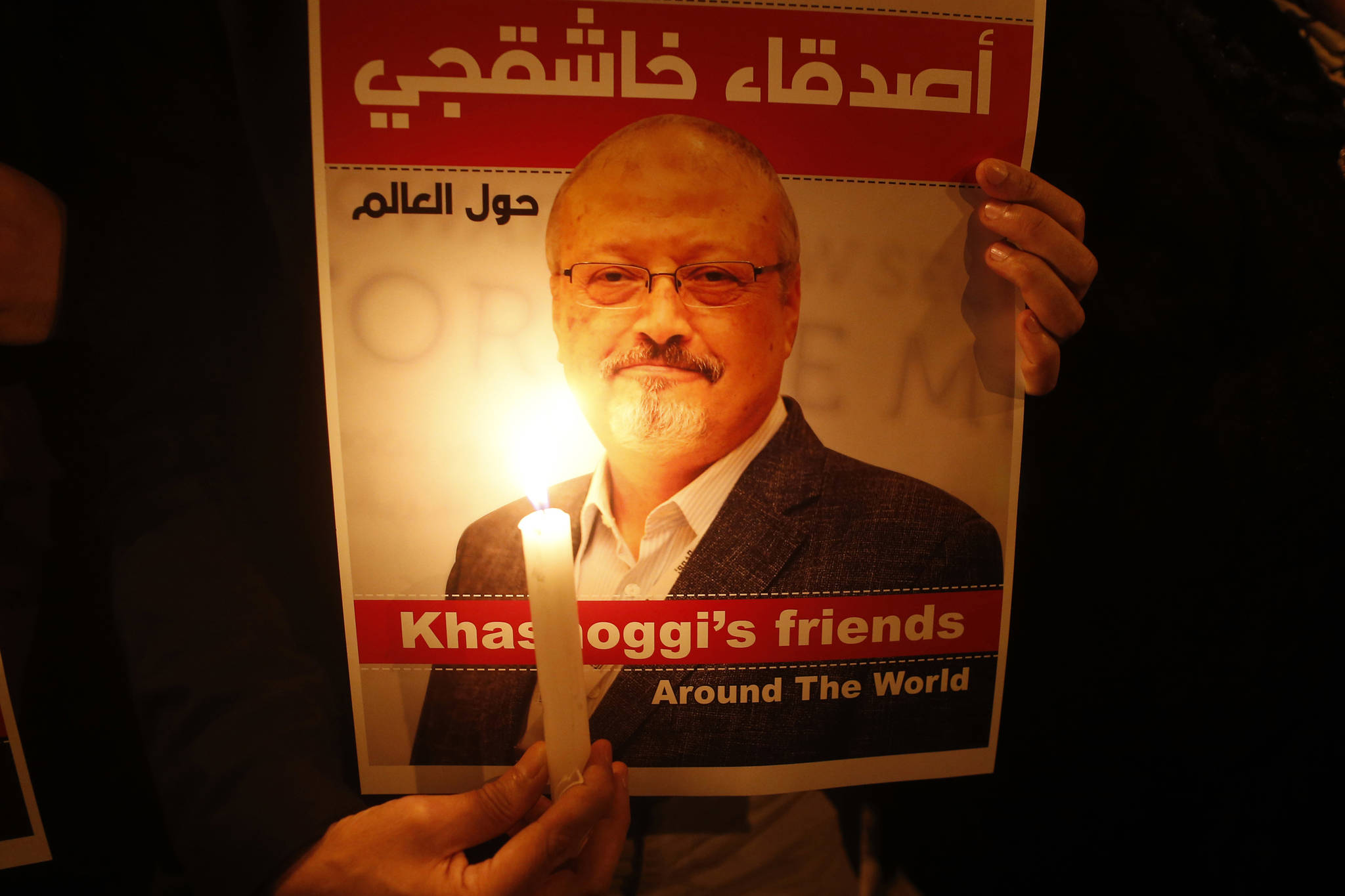 Activists, protesting the killing of Saudi journalist Jamal Khashoggi, hold a candlelight vigil outside Saudi Arabia’s consulate in Istanbul, Thursday, Oct. 25, 2018. The poster reads in Arabic:’ Khashoggi’s Friends Around the World’. A group of Arab and international public, political and media figures are establishing a global association called “Khashoggi’s Friends Around the World”; “to achieve justice for the freedom martyr”. (Lefteris Pitarakis | The Associated Press)