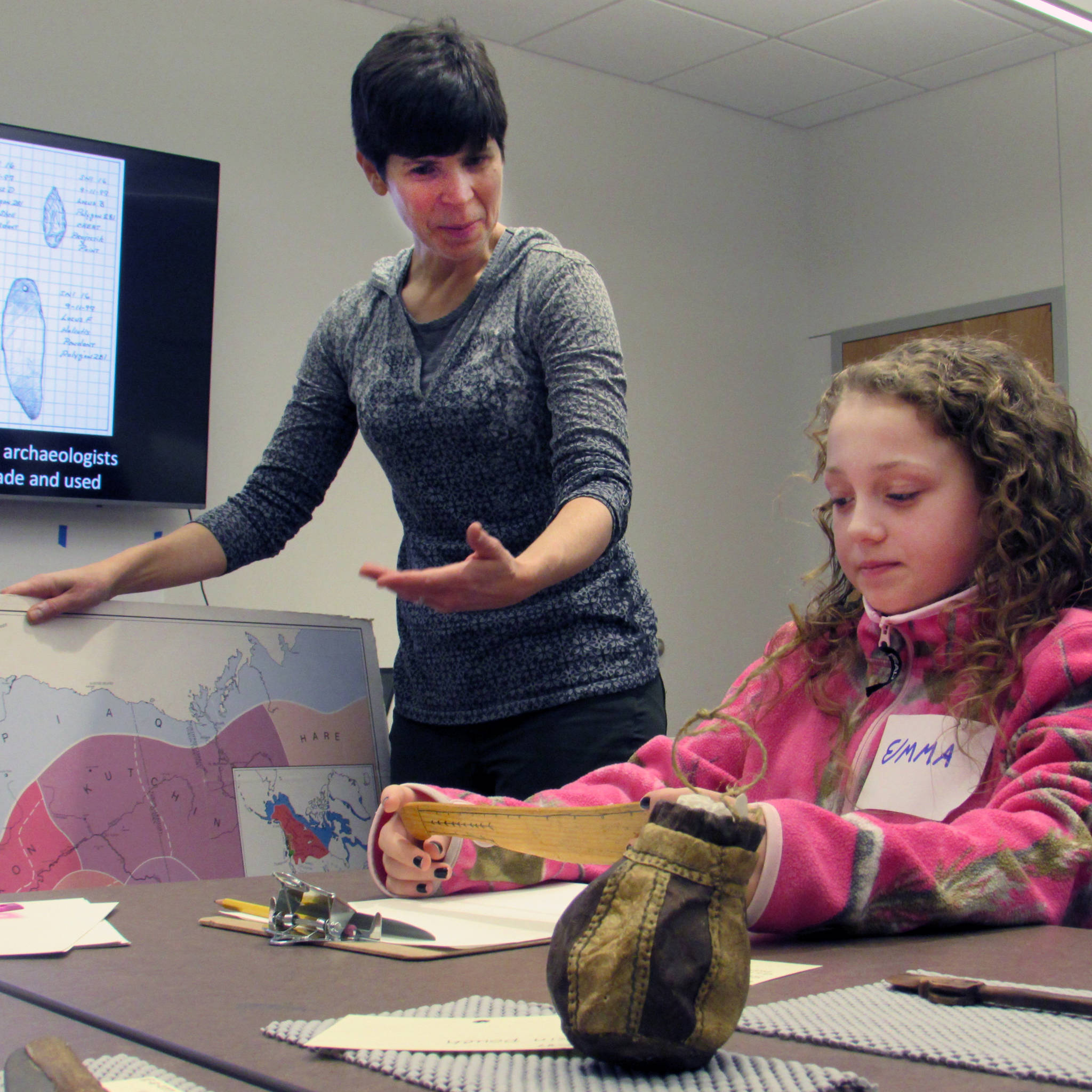 Science illustrator Kathy Hocker talks to Emma Dorsey, 10, who contemplates an artifact that she might sketch. (Ben Hohenstatt Capital City Weekly)