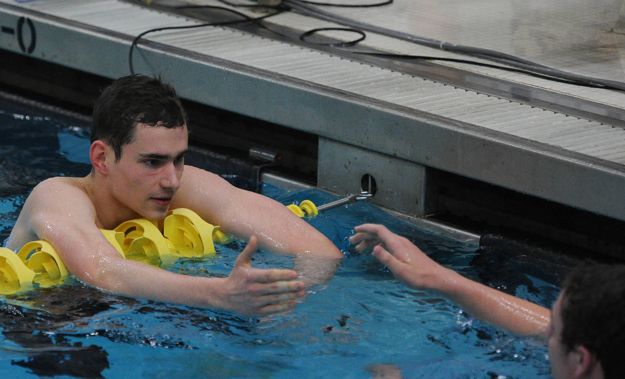 Thunder Mountain High School senior Raymie Matiashowski (second place, 4:52.83) congratulates teammate Micah Grigg (sixth place, 4:56.97) following the 500-yard freestyle at the ASAA/First National Bank Alaska State Swim and Dive Championships on Saturday, Nov. 3, 2018. The Falcons boys were awarded the team sportsmanship award for the second year in a row at the meet. (Michael Dinneen | For the Juneau Empire)