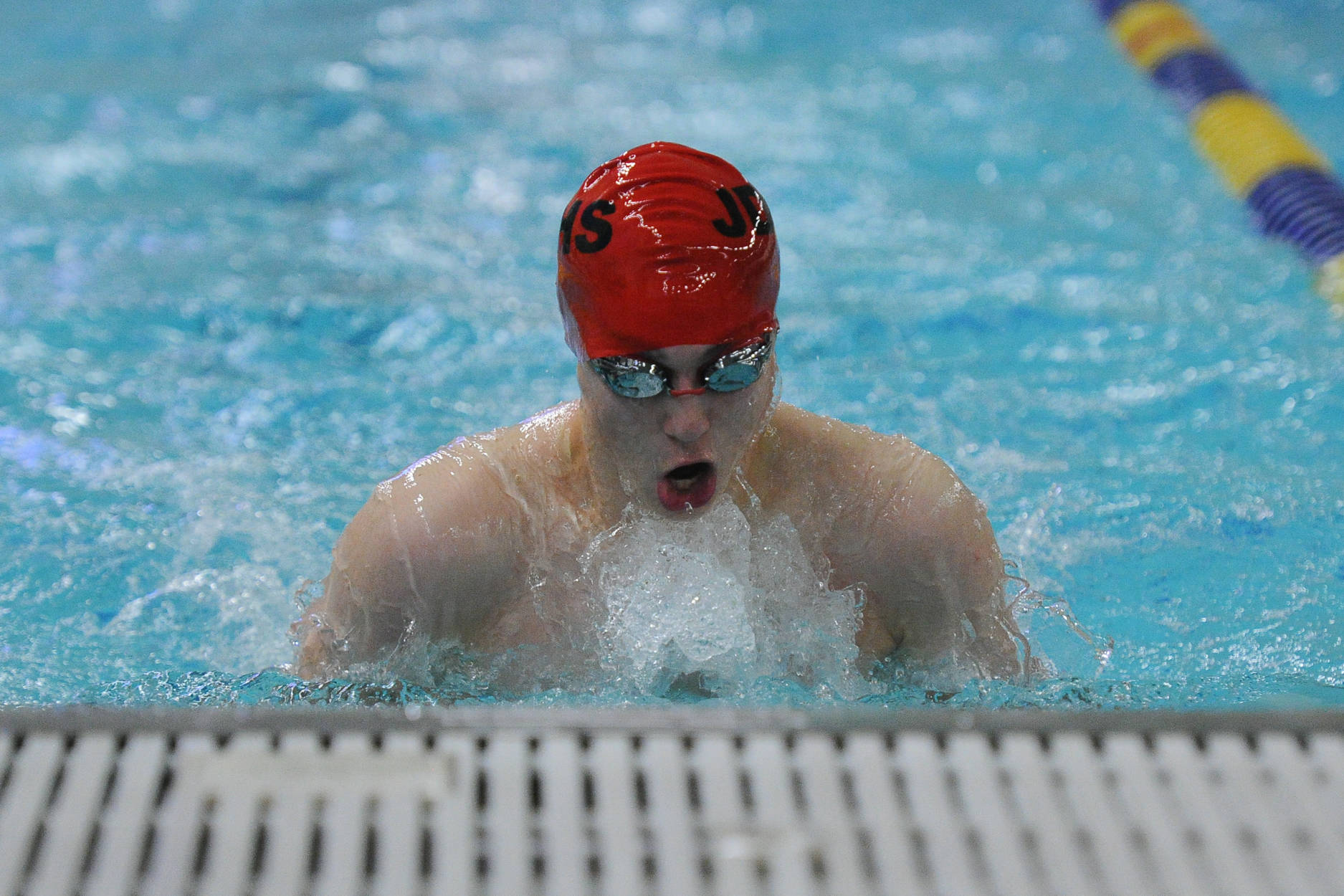 Juneau-Douglas High School senior Tyler Weldon swims in the finals of the 100-yard breaststroke. He finished in sixth place with a time of 1:02.66. (Michael Dinneen | For the Juneau Empire)