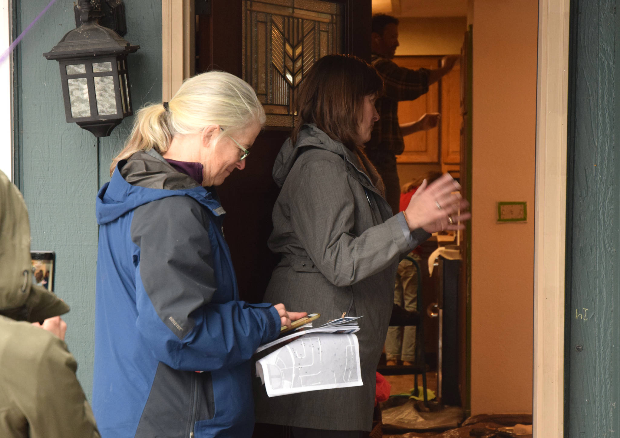 Alyse Galvin, Alaska’s independent candidate for U.S. House of Representatives, talks to a woman named Amanda (not pictured) while going door to door for support Sunday, Nov. 4, 2018 in the Mendenhall Valley. Galvin was in Juneau for a final campaign stop ahead of the election. (James Brooks | Juneau Empire)