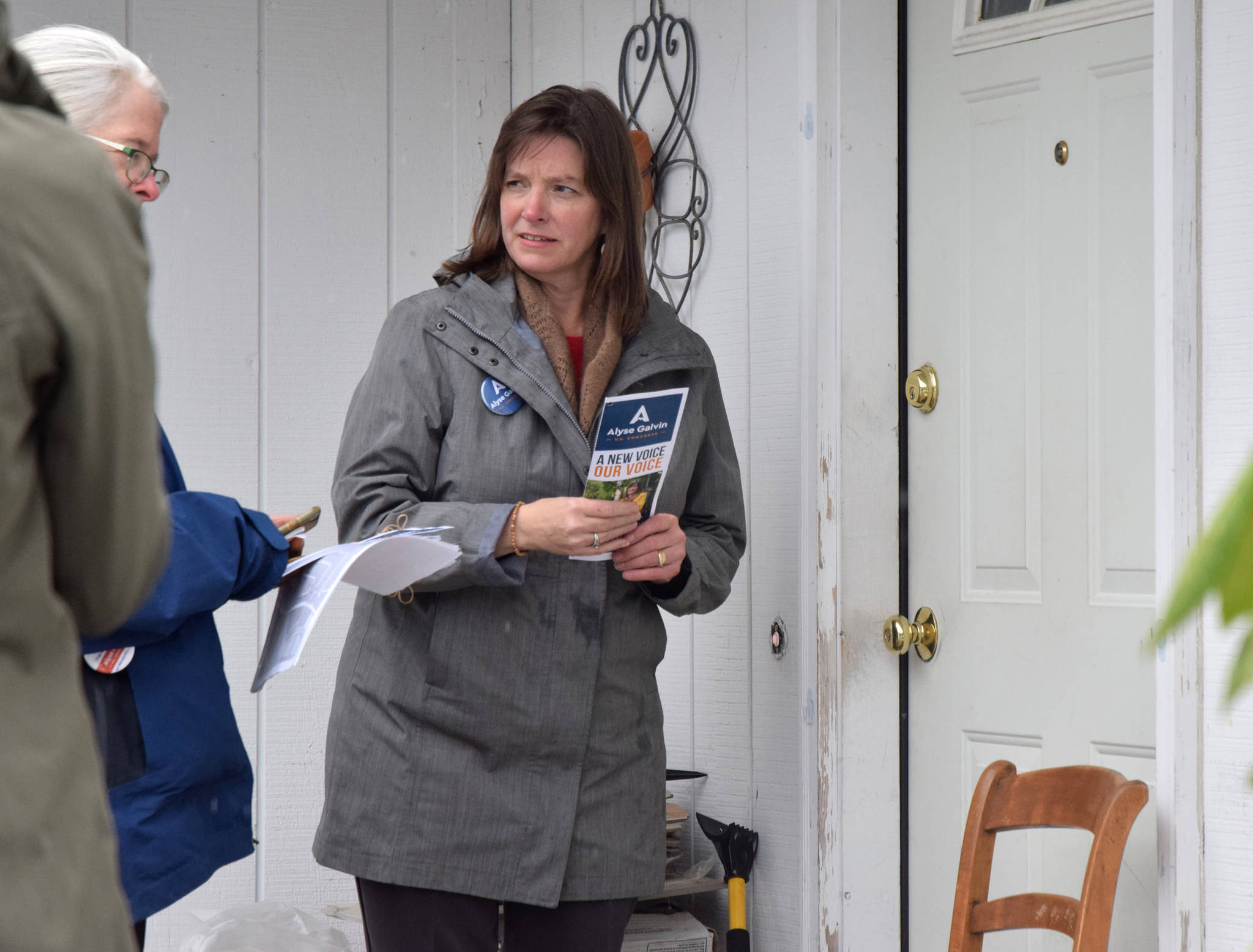 Alyse Galvin, Alaska’s independent candidate for U.S. House of Representatives, prepares to leave a signed brochure while going door to door Sunday, Nov. 4, 2018 in the Mendenhall Valley. (James Brooks | Juneau Empire)