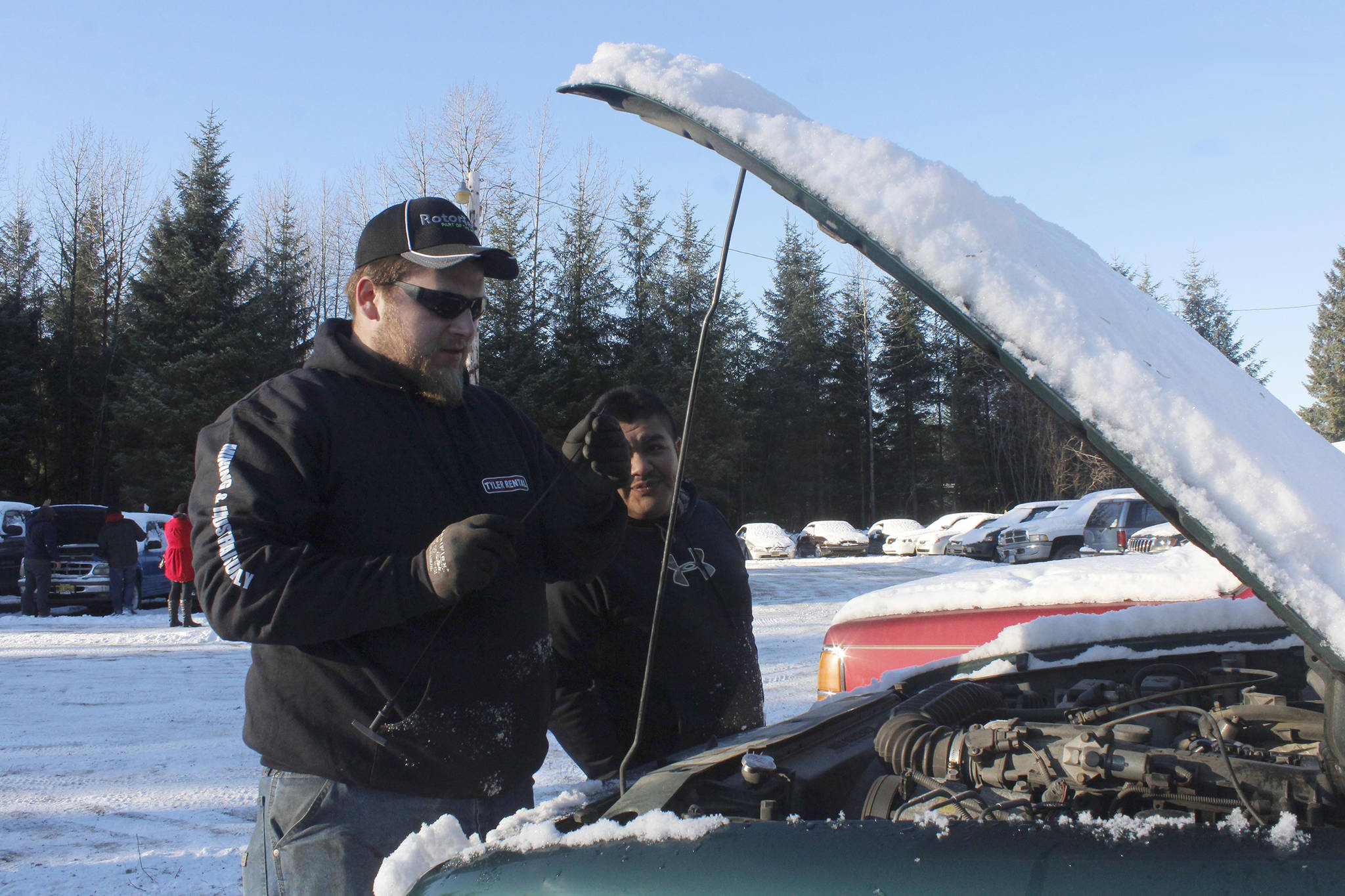 Cody Wilkie, left, and Robert Beltz examine a Ford Ranger at the open viewing of the Juneau Police Department’s impounded vehicles on Wednesday, Nov. 15, 2017. (Alex McCarthy | Juneau Empire File)