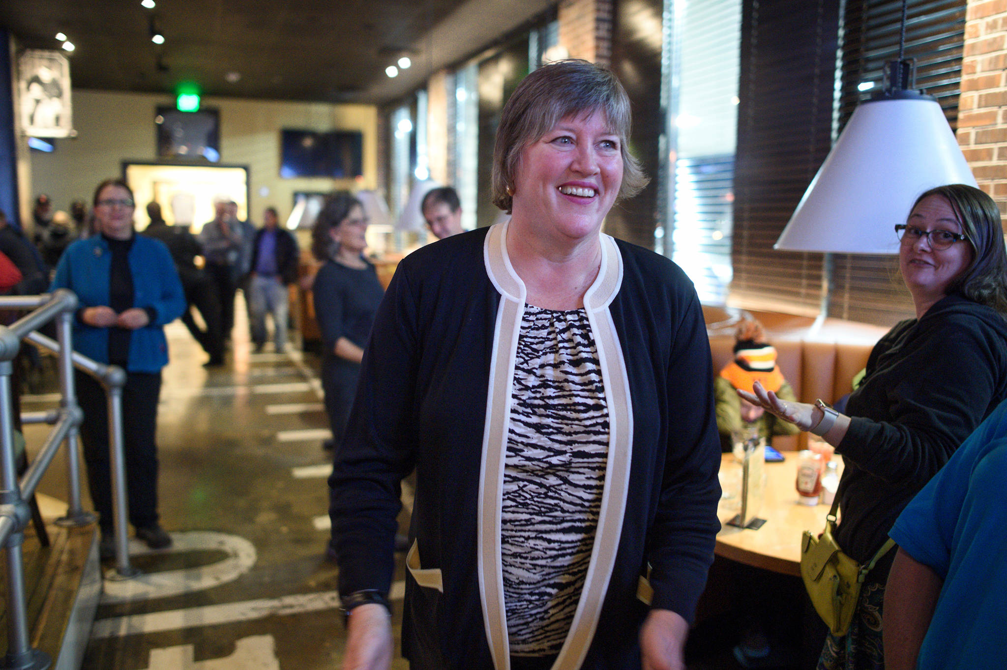 Sara Hannan, Democratic candidate for House Distric 33, walks into McGiveny’s Sports Bar and Grill on election night. Hannan won her race over independent candidate Chris Dimond. (Michael Penn | Juneau Empire)