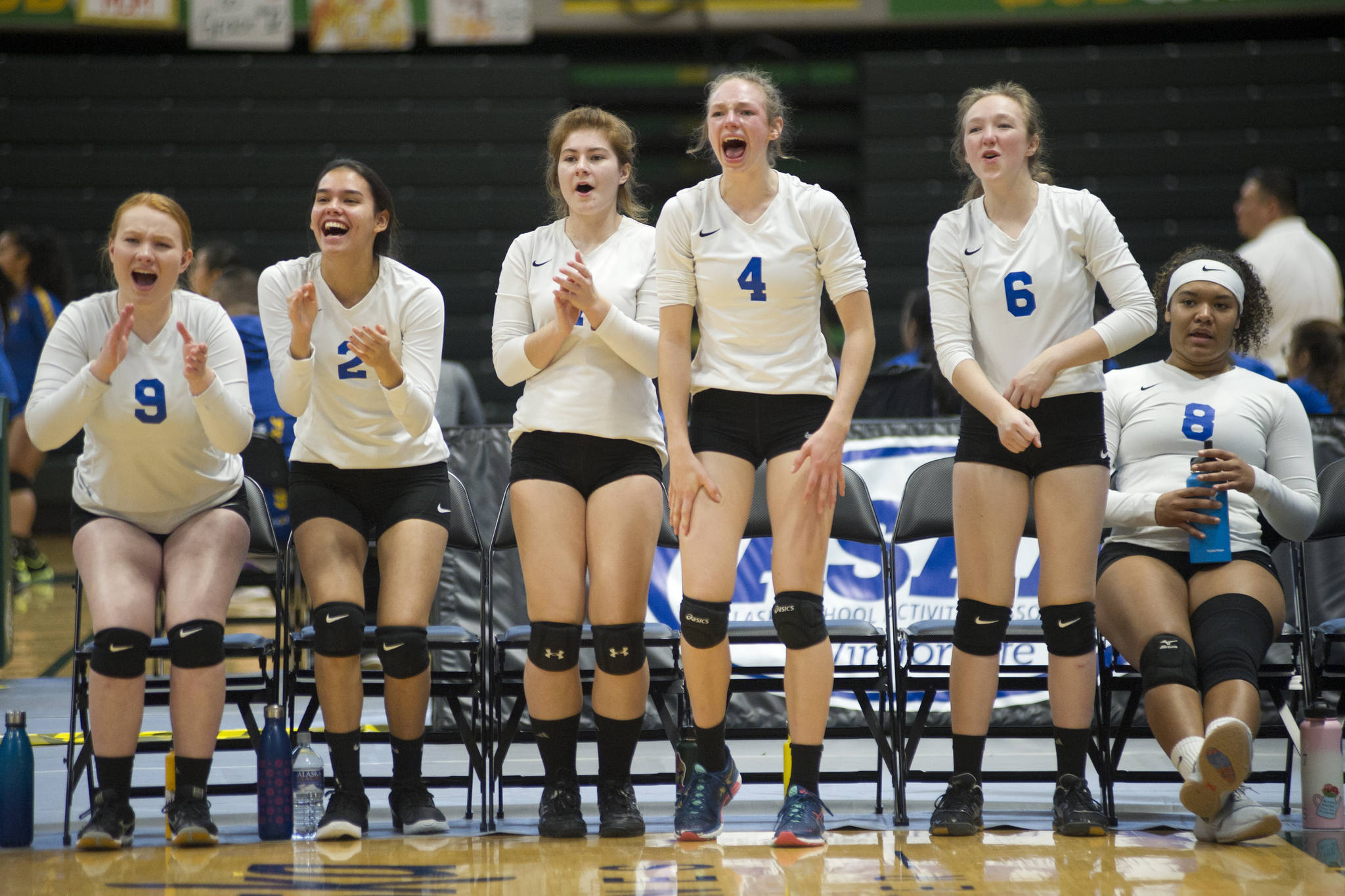 The Thunder Mountain High School bench celebrates a point against West Valley at the ASAA/First National Bank Alaska 3A/4A Volleyball State Championships on Friday at the Alaska Airlines Center in Anchorage. From left: Alex Murray, Amy Schoonover, Kiley Stevens, Sophia Harvey, Hannah Harvey, Kyra Jenkins Hayes. (Nolin Ainsworth | Juneau Empire)