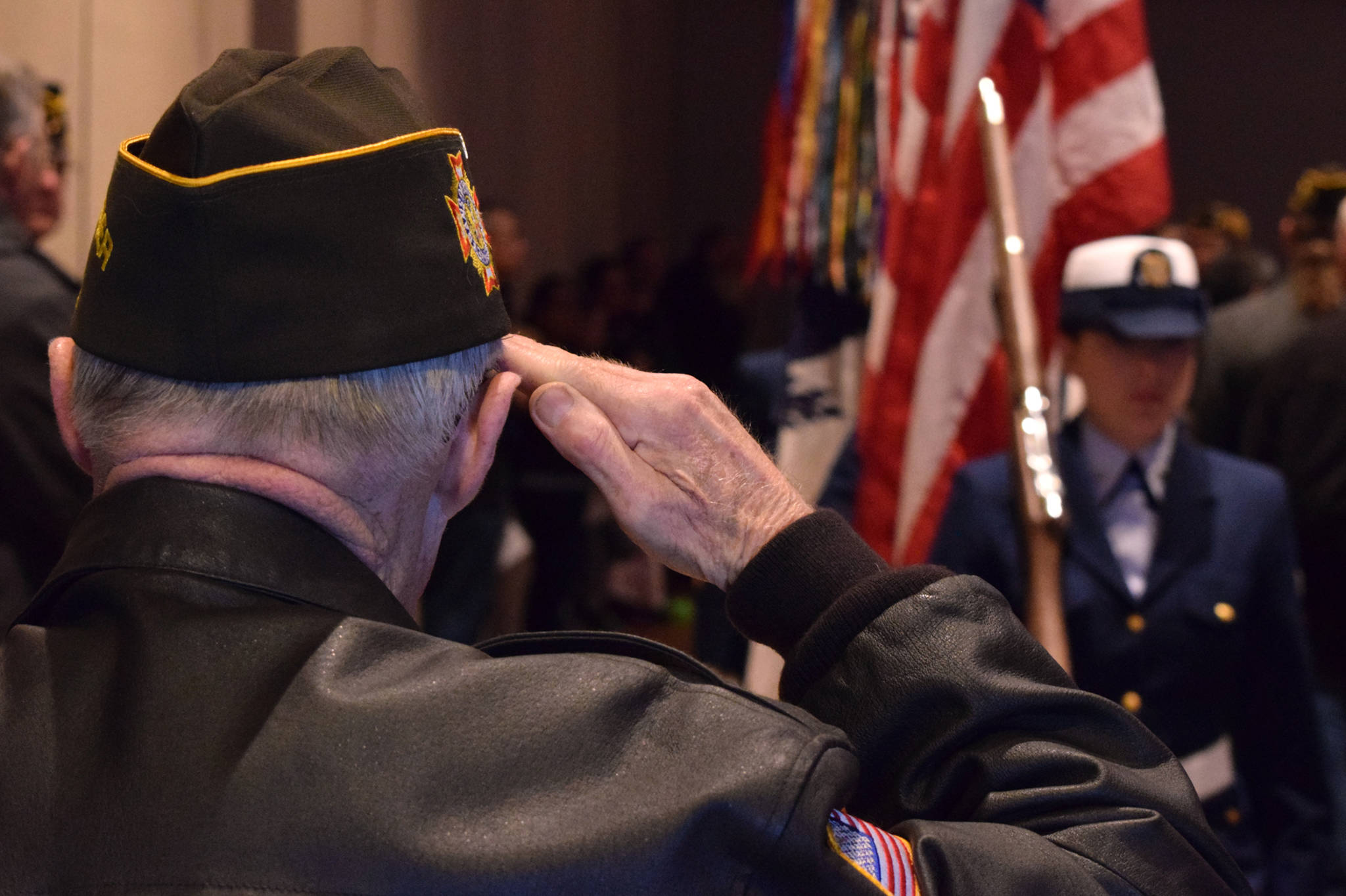 Veteran George Roberts salutes the flag as the U.S. Coast Guard color guard leaves a Centennial Hall ballroom at the conclusion of Veterans Day ceremonies Wednesday, Nov. 11, 2015. (James Brooks | Juneau Empire File)
