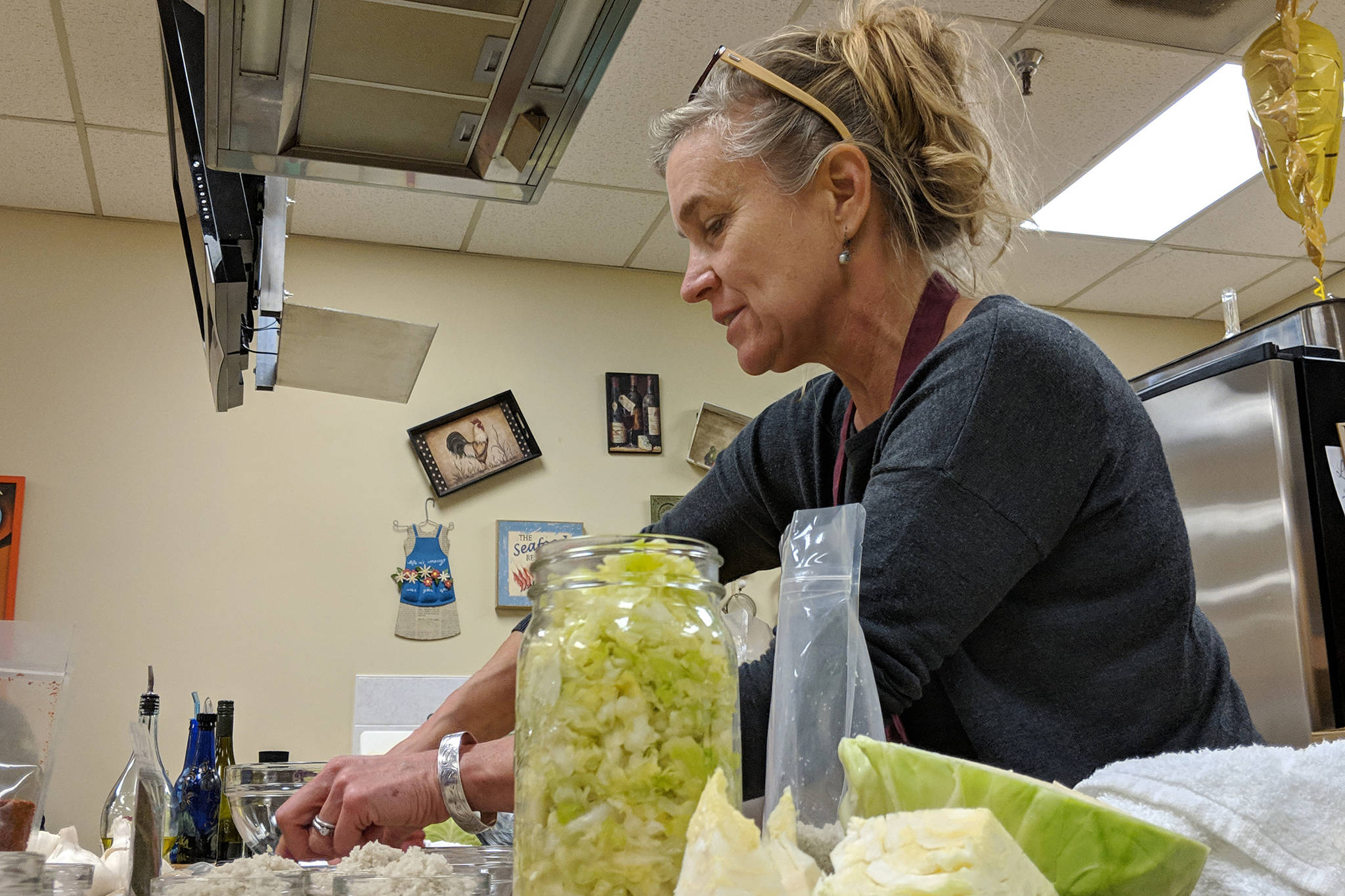 Julie O’Brien, a former Juneauite, UAS alumna and owner of Firefly Kitchens, prepares ingredients ahead of Fermentation 101 Friday, Nov. 9, at Chez Alaska Cooking School. The workshop detailed the purported health benefits of fermented foods and taught attendees how to make their own at home. (Ben Hohenstatt | Capital City Weekly)