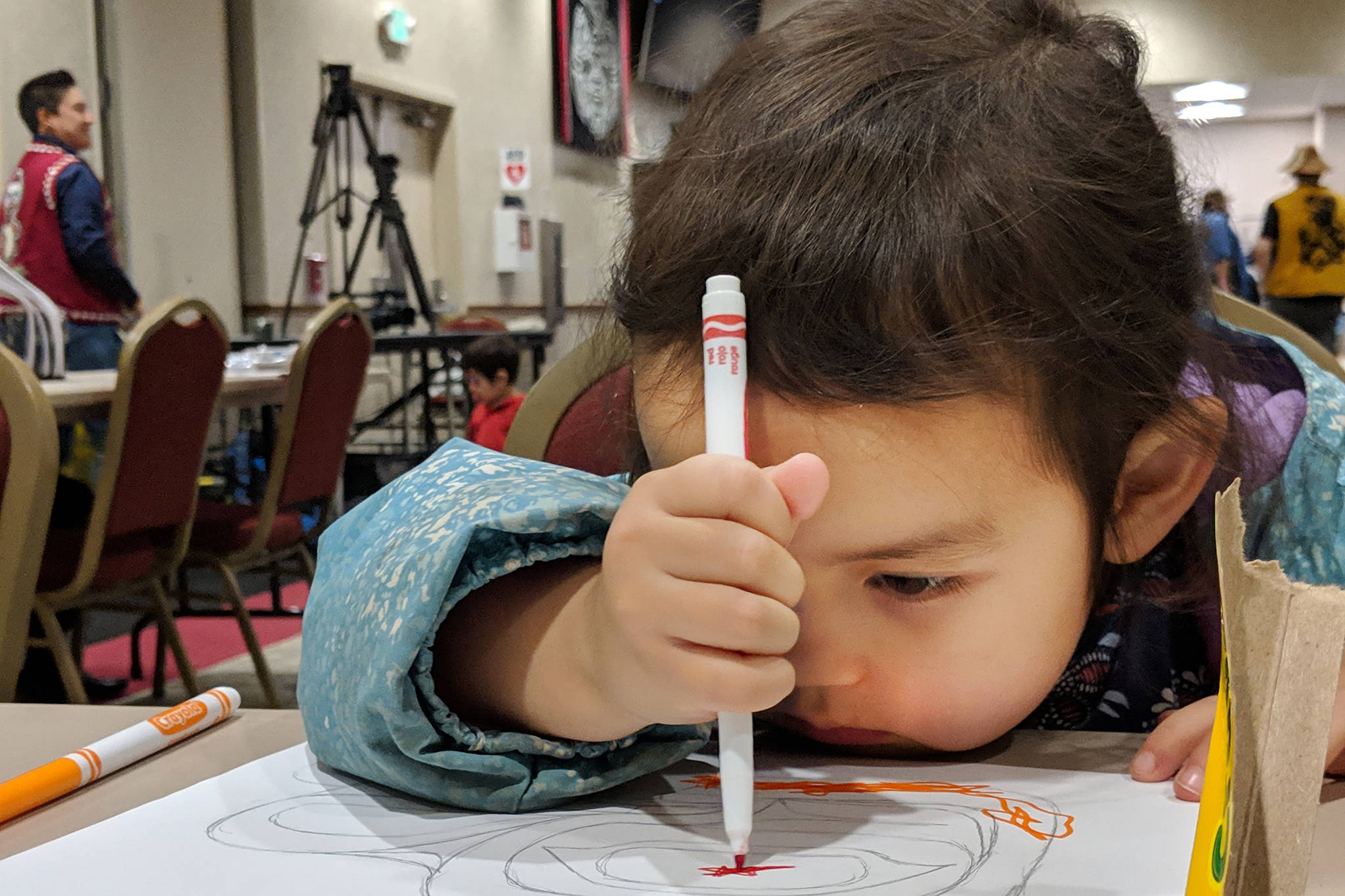 Mary Hope, 4, colors in a formalize drawing by master artist Ryan Abel during Rock Your Mocs, a celebration of Alaska Native culture organized by Goldbelt Heritage Foundation. (Ben Hohenstatt | Capital City Weekly)