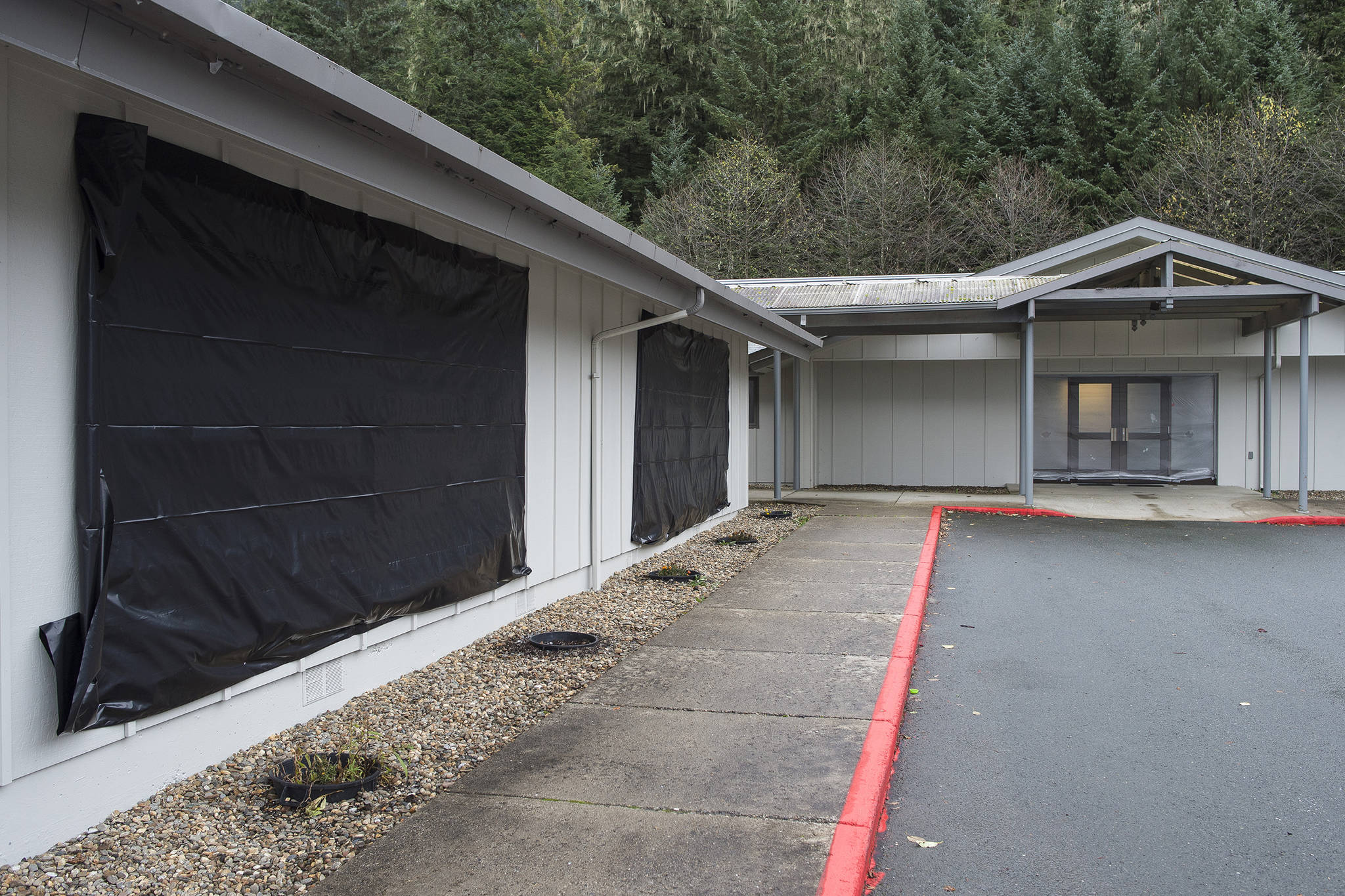Broken windows are covered up at The Church of Jesus Christ of Latter-day Saints on Wednesday, Oct. 24, 2018, after reports of vandalism on Monday night. (Michael Penn | Juneau Empire File)