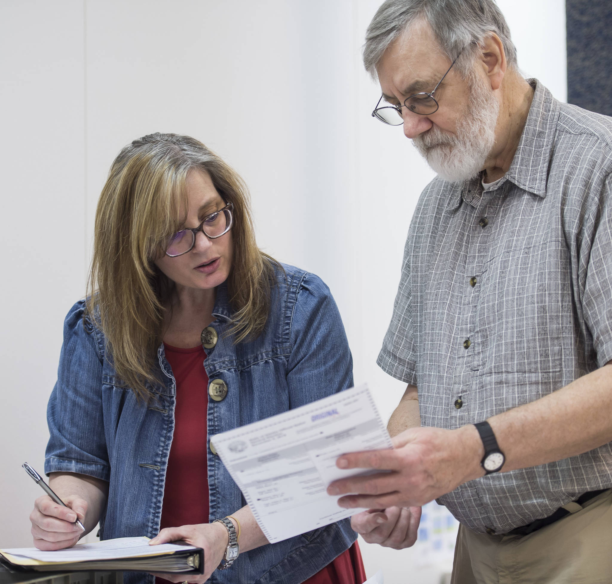 Lauri Wilson, Region 1 Election Supervisor, and Regional Accu-Vote board member David Clover look over a questioned ballot from a Southeast district that failed to run through an Accu-Vote machine at the State of Alaska Election Office in the Mendenhall Mall Annex on Tuesday, Nov. 13, 2018. (Michael Penn | Juneau Empire)