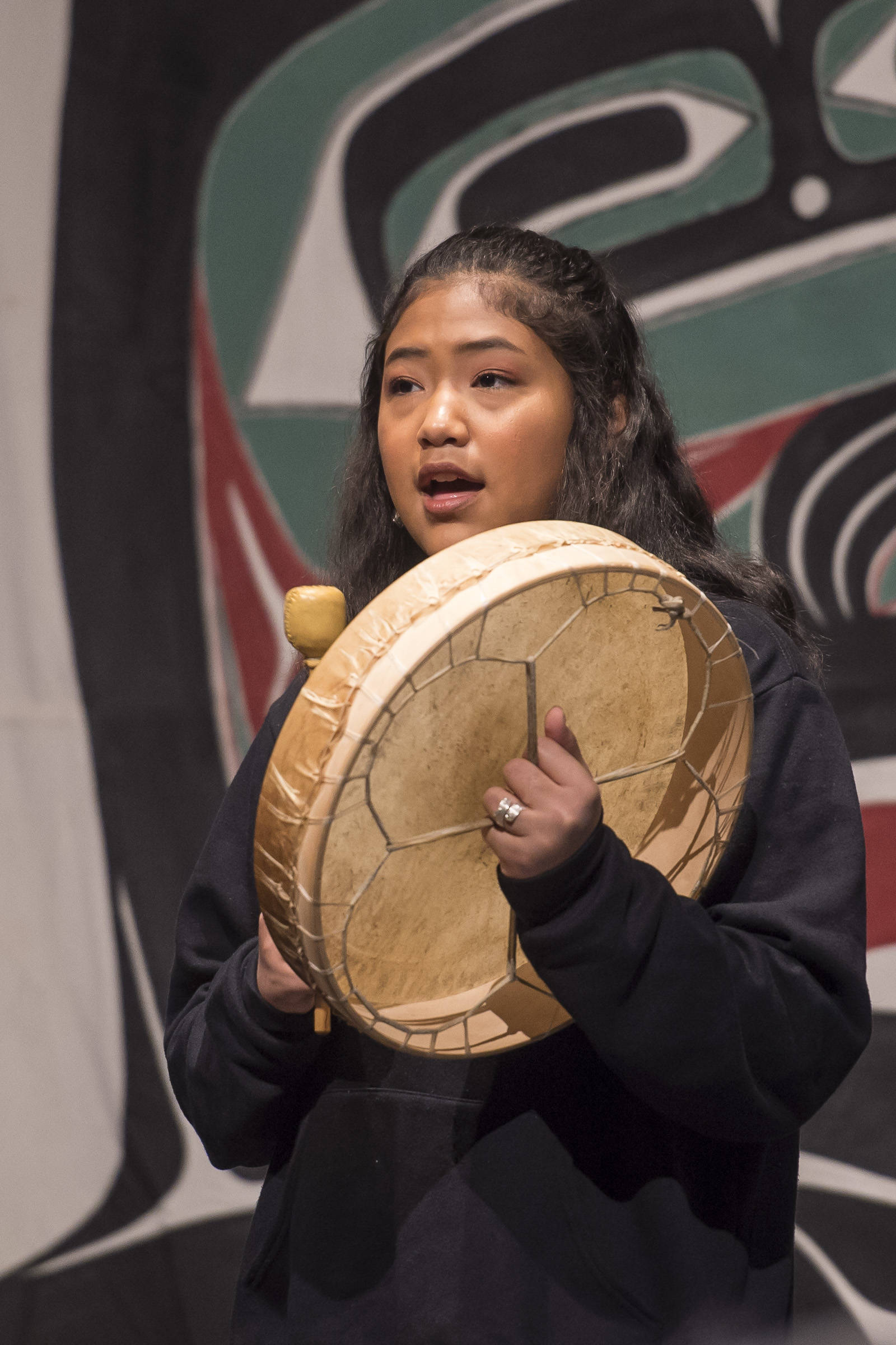 Gabrielle Shaawatgoox George-Frank, of Angoon, sings a song to start the day at the Voices of Our Ancestors Language Summit at Centennial Hall on Wednesday, Nov. 14, 2018. (Michael Penn | Juneau Empire)