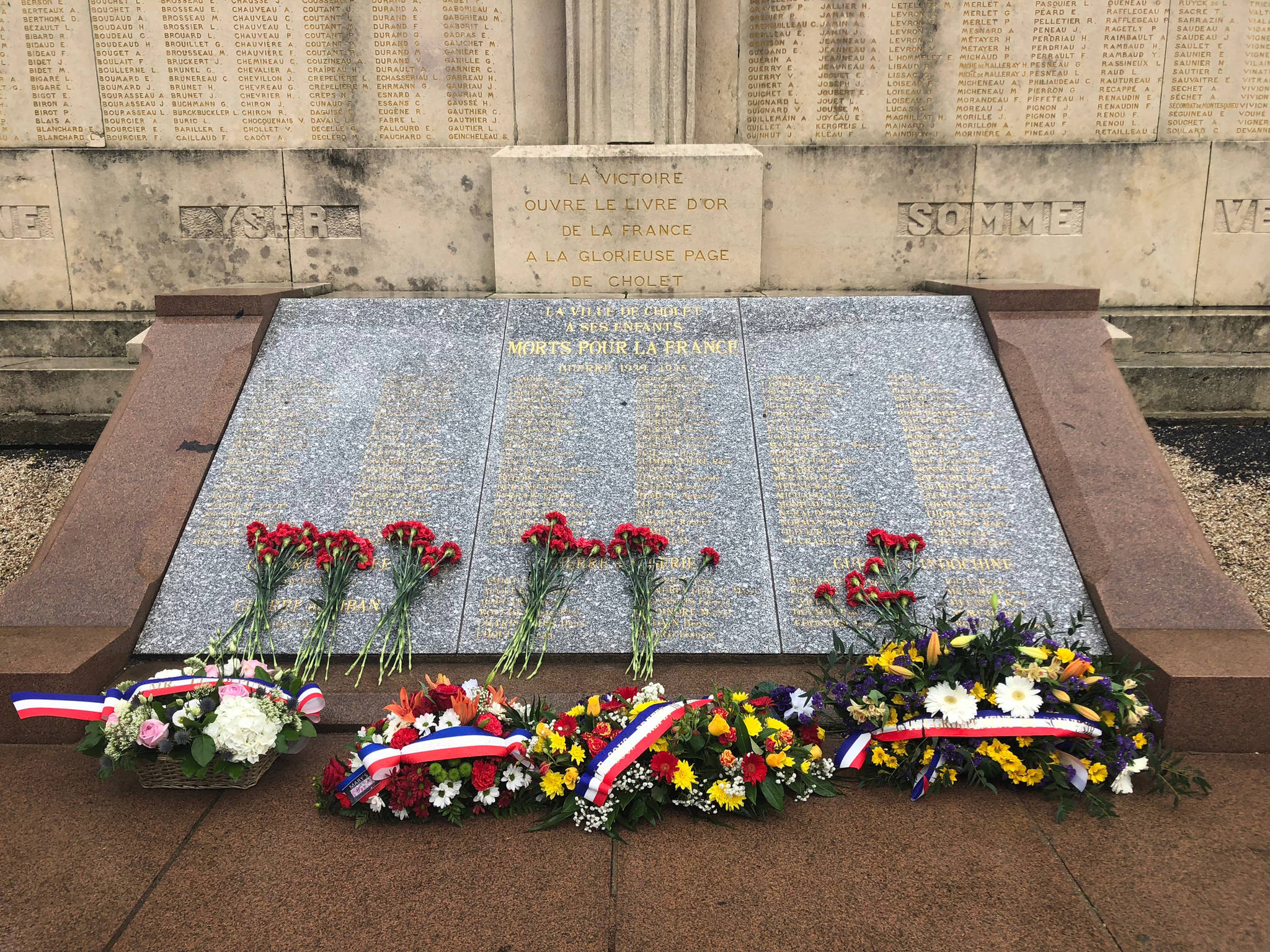 Flowers placed on the “Monument aux Morts” in front of the Gare de Cholet. (Bridget McTague | For the Juneau Empire)