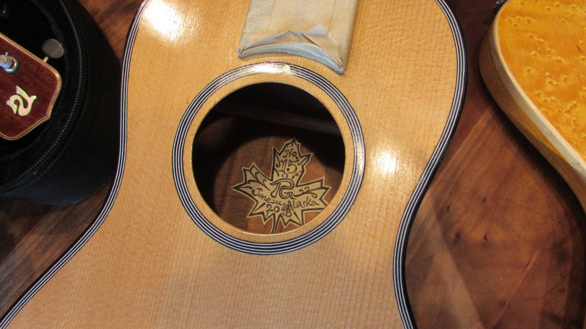 Paul Gardinier includes a hand drawn label on most of the instruments he makes. He said when you invest 40-60 hours into making a guitar or ukulele, spending another hour on a label seems insignificant. (Ben Hohenstatt | Capital City Weekly)