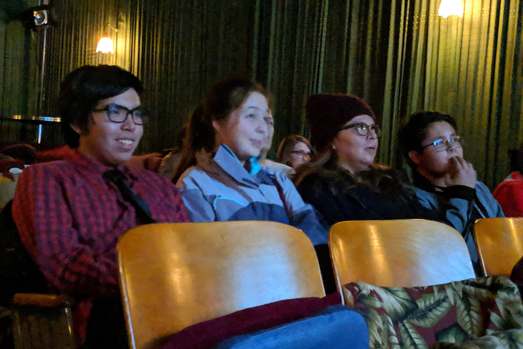 Michael Martin Jr., whose short film “Adapt” screened during a showing of “Our Alaskan Stories” watches his movie with his girlfriend, Annie Masterman; mom, Michelle Martin; and brother, Micheel Martin at Gold Town Nickelodeon Saturday, Nov. 17. (Ben Hohenstatt | Capital City Weekly)
