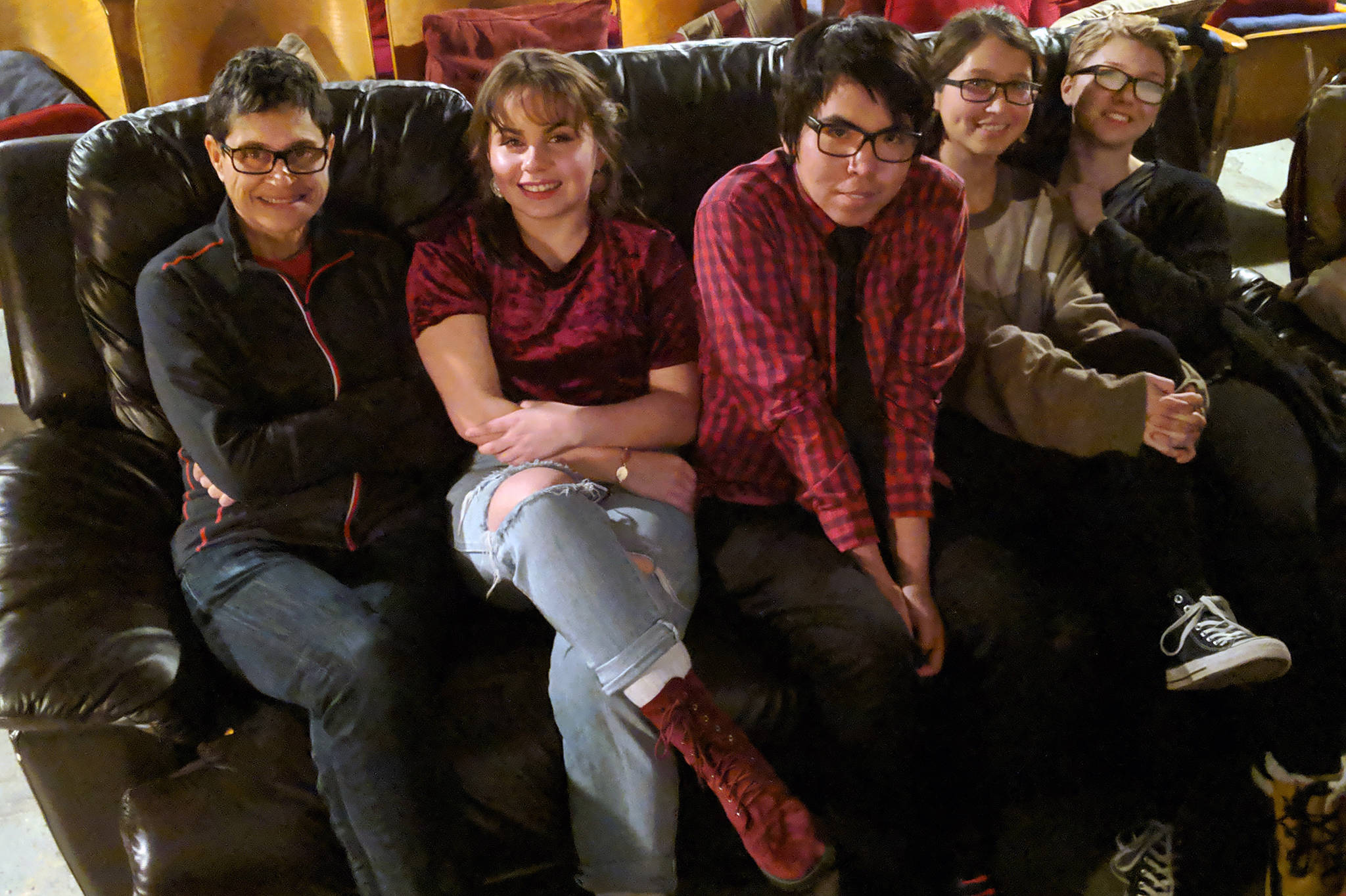 Writer Gina Cole and filmmakers Andrea Cook, Michael Martin Jr., Alyssa Afcan and Haley Shervey, cram onto the couch in the Gold Town Nickelodeon Saturday, Nov. 17. The five were in town for a screening of “Our Alaskan Stories” short films. (Ben Hohenstatt | Capital City Weekly)