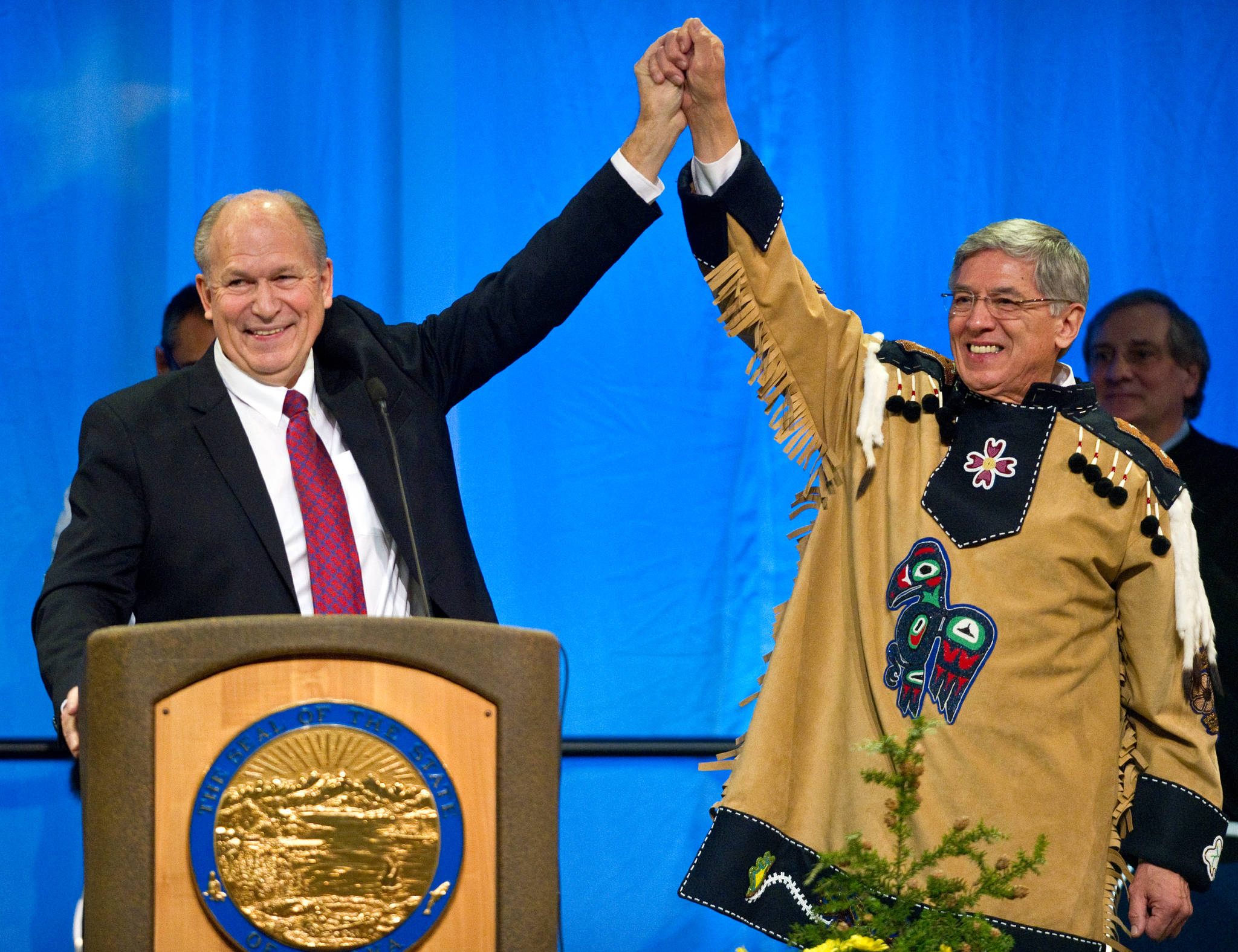 In this Dec. 1, 2014 photo, Gov. Bill Walker, left, and Lt. Gov. Byron Mallott join hands on stage at the end of inauguration ceremonies at Centennial Hall. (Michael Penn | Juneau Empire File)