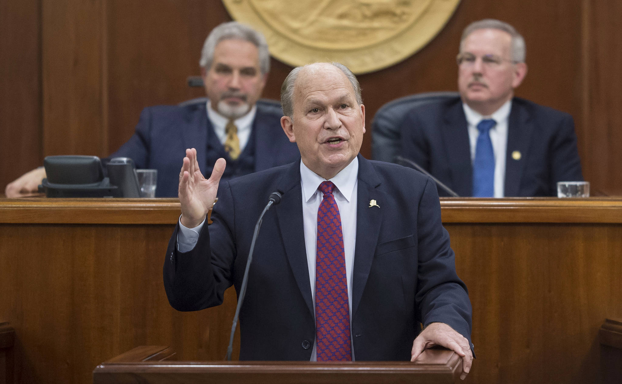 In this Jan. 18 photo, Gov. Bill Walker speaks during his State of the State address before a joint session of the Alaska Legislature at the Capitol. Senate President Pete Kelly, R-Fairbanks, left, and Speaker of the House Bryce Edgmon, D-Dillingham, watch from the Speakers desk in the background. (Michael Penn | Juneau Empire File)