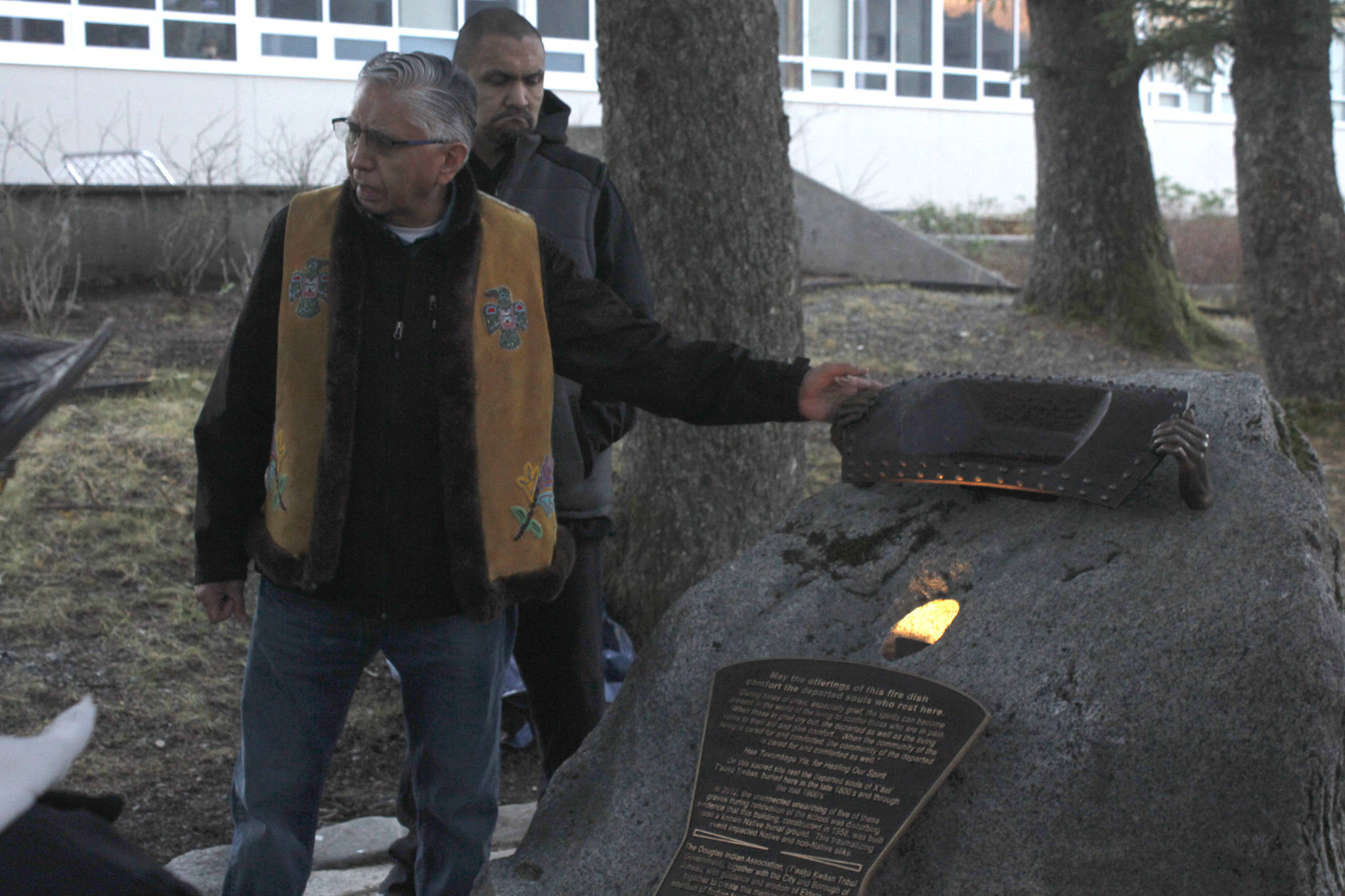 Tlingit elder Paul Marks presents the Sayéik Sacred Site Memorial on Friday, Nov. 23, 2018. The memorial, placed at Sayéik Gastineau Community School, is a tribute to the people who were buried in the Tlingit burial ground that was paved over for the road and school. (Alex McCarthy | Juneau Empire)