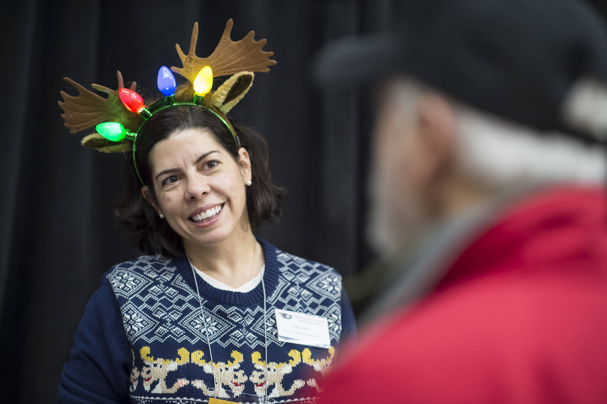 Julie York Coppens, Director of Outreach and Engagement for Perseverance Theatre, mans the theater’s booth at the Public Market in the Elizabeth Peratrovich Hall on Friday, Nov. 23, 2018. (Michael Penn | Juneau Empire)