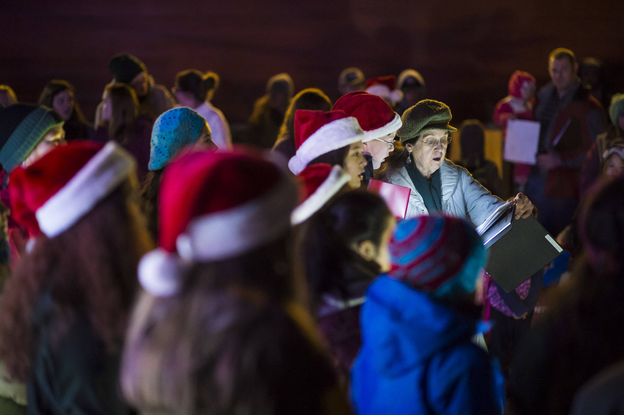 Members of The Voices of Alaska, directed by Missouri Smyth, sing Christmas carols at the annual Douglas Christmas Tree lighting at the Douglas Community United Methodist Church on Friday, Nov. 23, 2018. (Michael Penn | Juneau Empire)