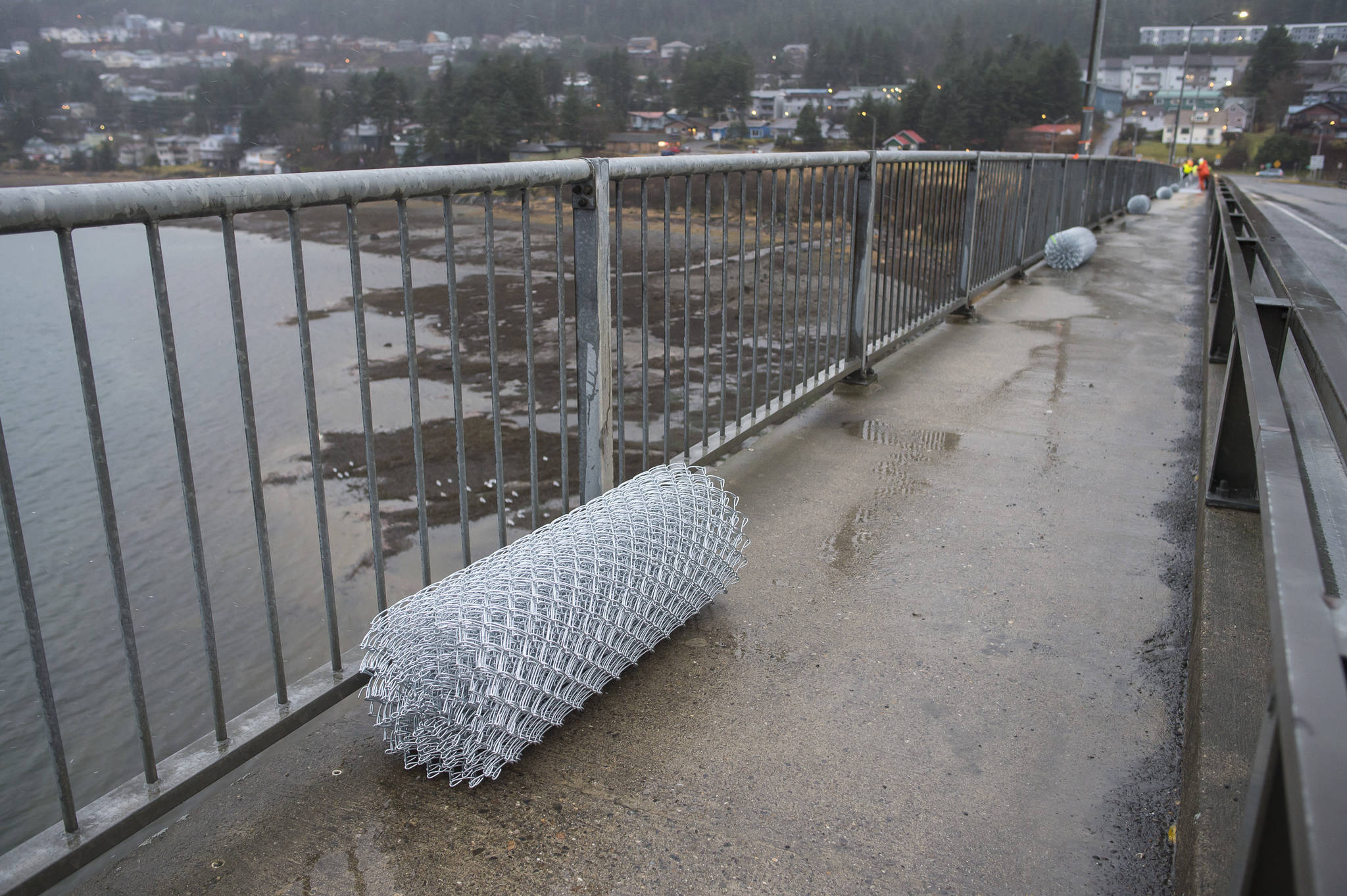 Rolls of chain-link fencing sit ready to be installed by the Department of Transportation and Public Facilities along the pedestrian walkway over the Douglas Bridge on Monday, Nov. 26, 2018. (Michael Penn | Juneau Empire)