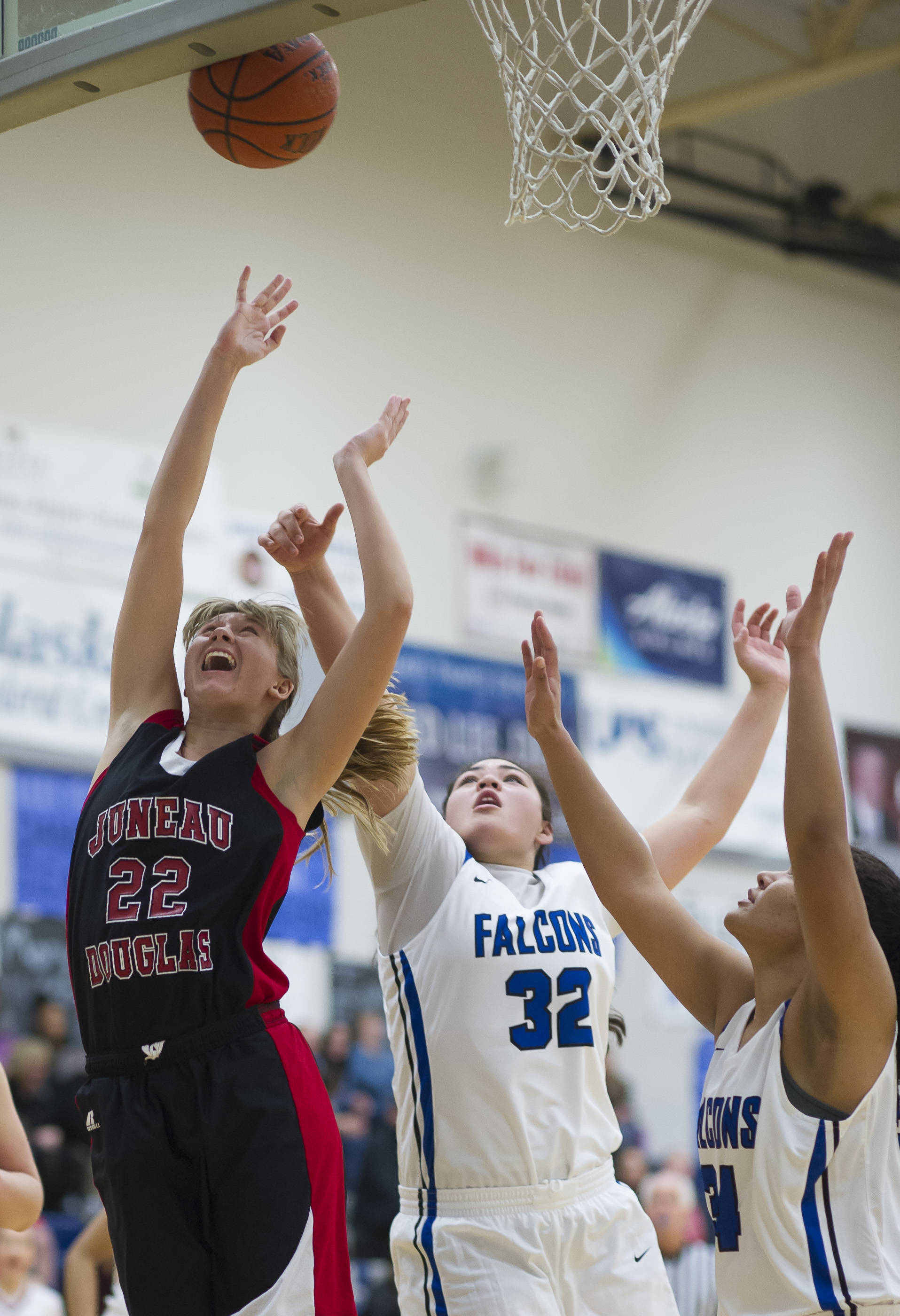 Juneau-Douglas Caitlin Pusich, left, shoots under the basket against Thunder Mountains Nina Fenumiai, center, and Kyra Jenkins-Hayes during their game at TMHS on Friday, Jan. 5, 2017. JDHS won 53-33. (Michael Penn | Juneau Empire File)