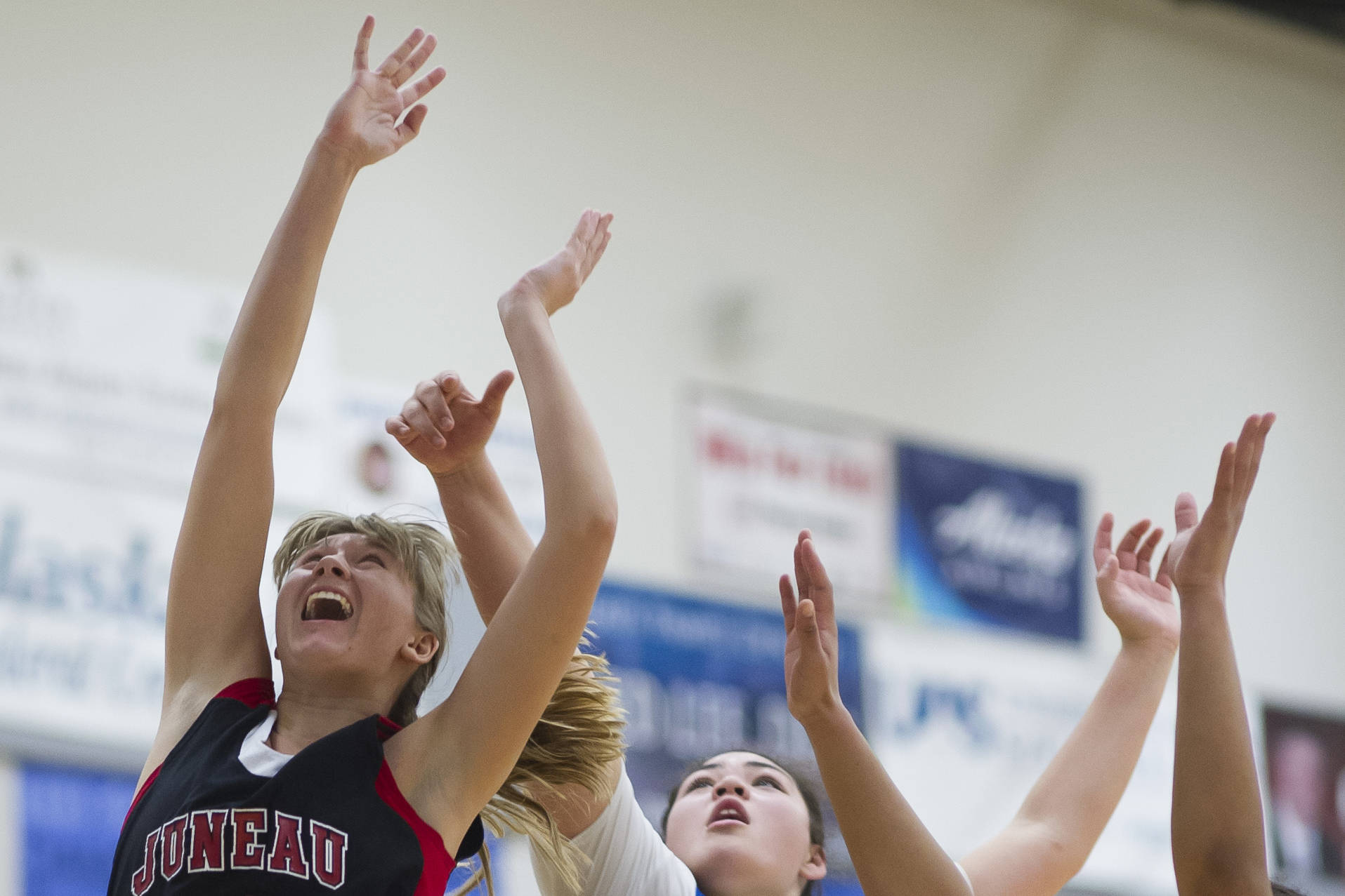 Juneau-Douglas’ Caitlin Pusich, left, shoots under the basket against Thunder Mountain’s Nina Fenumiai, center, and Kyra Jenkins-Hayes during their game at TMHS on Friday, Jan. 5, 2017. JDHS won 53-33. (Michael Penn | Juneau Empire File)